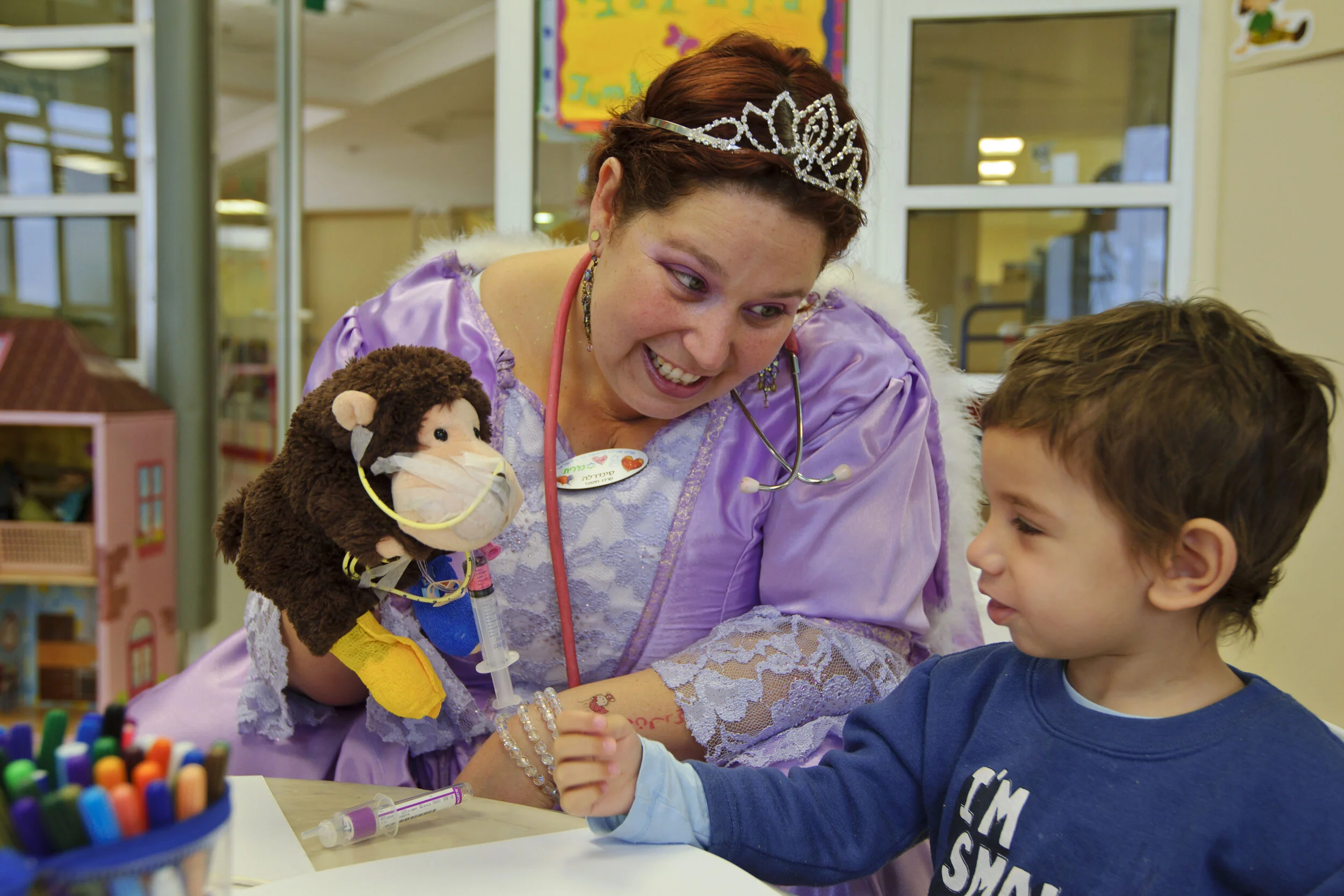 “Cinderella” hospital clown with Nevo, almost 3  The hospital clowns play an important role in supporting the child during treatment and recovery.   Heartbeat  © Photo by Ziv Koren