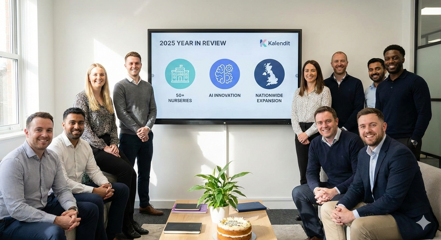 Kalendit team members posing in a modern office in front of a large screen displaying their "2025 YEAR IN REVIEW" achievements, including "50+ NURSERIES," "AI INNOVATION," and "NATIONWIDE EXPANSION," with a celebratory cake on the table.