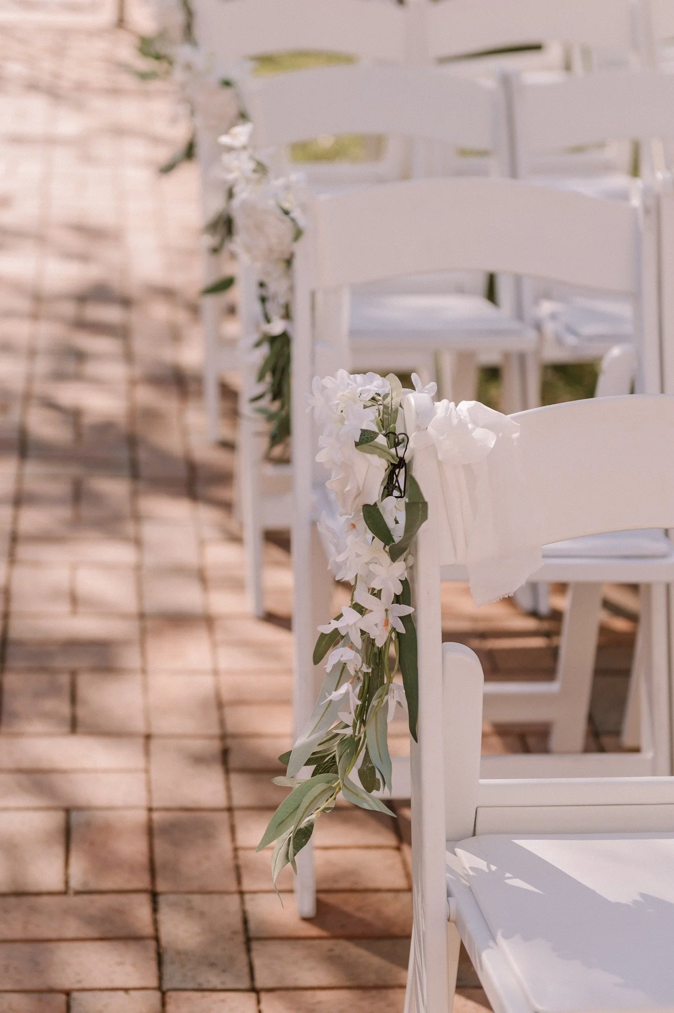 Adding blooms to your ceremony chairs brings beauty, softness, and a fresh touch that ties your whole aisle together. Whether you go with clusters of roses, sprigs of greenery, or just a single stem, it&rsquo;s the perfect way to say &ldquo;welcome&r
