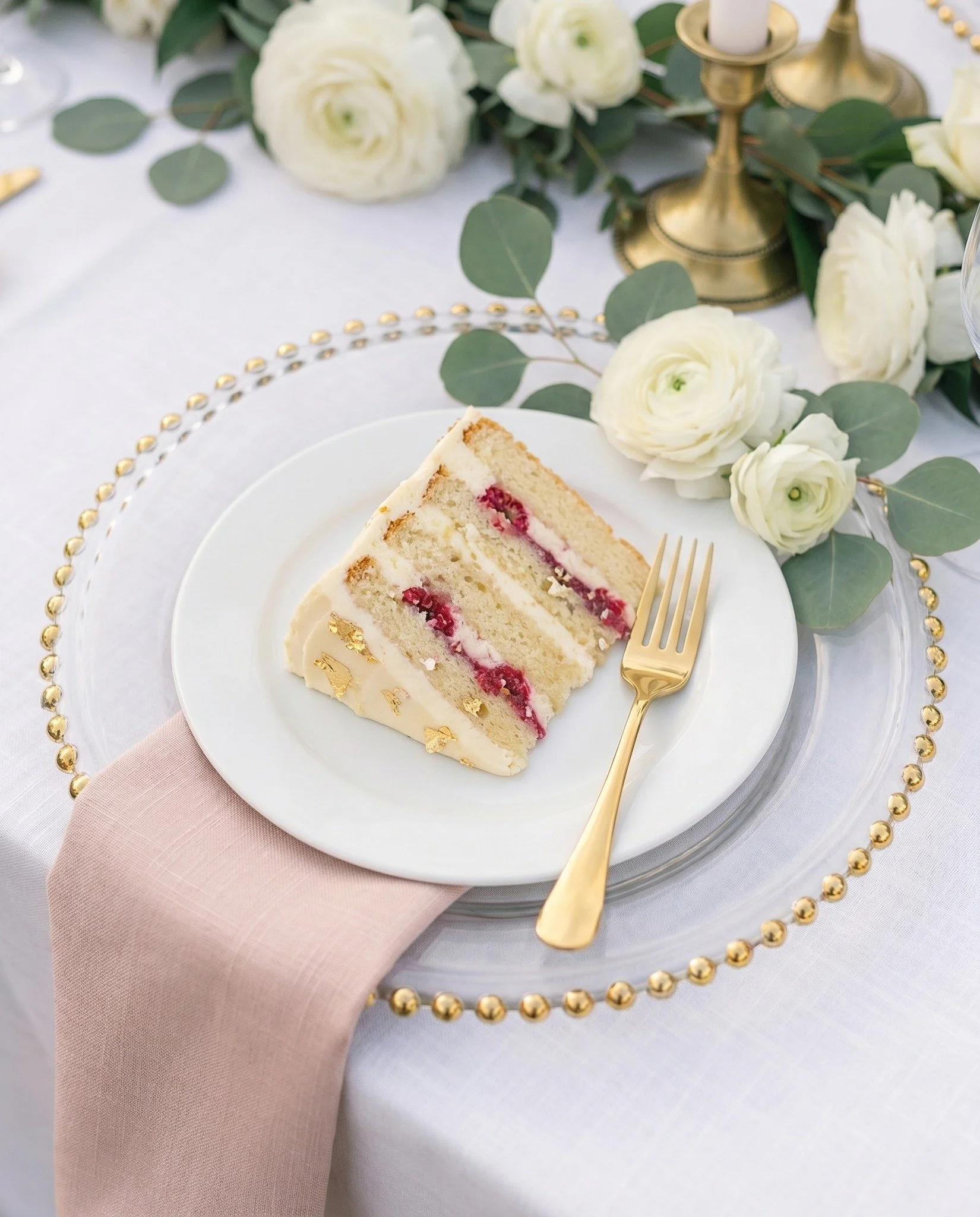 That gorgeous slice of raspberry cake, paired with our glass beaded gold charger plate and gold flatware, is exactly the kind of magic that happens at a wedding reception! 

Here's the thing...we don't do the flowers or the cake... but WE supply the 