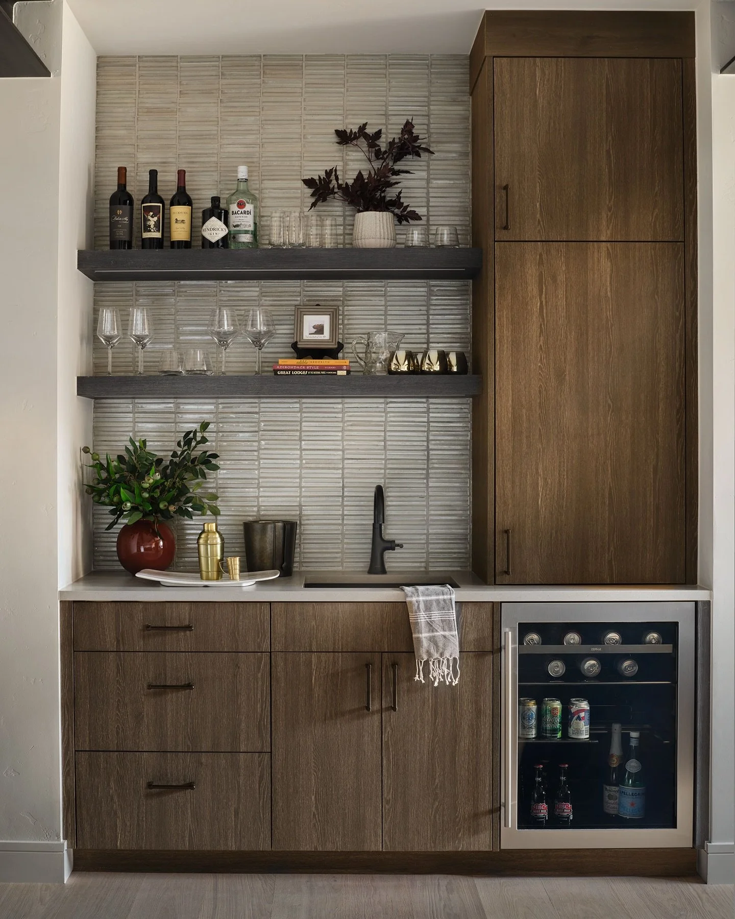 🍸 Cheers to the details that make a space shine!  Our client&rsquo;s wet bar proves that a small corner can make a statement- pairing sleek cabinetry, glass tile and functional accessories are the perfect mix of function and flair, ready for cocktai