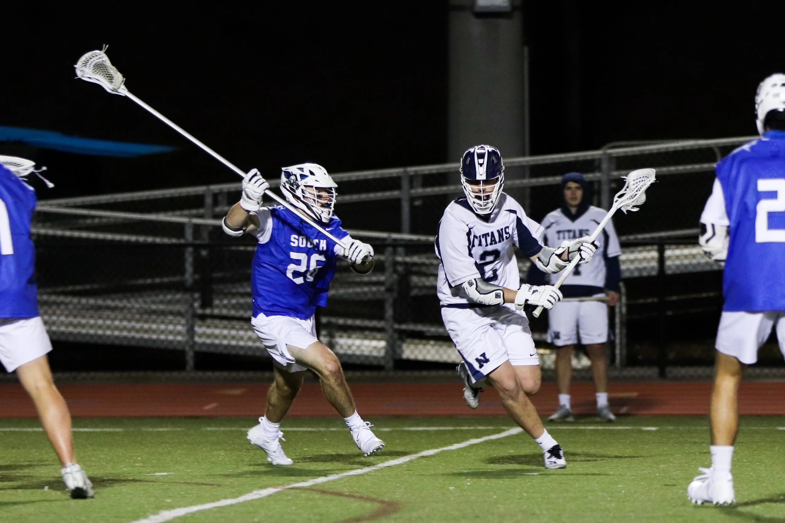 Senior Luke Bolton escapes the defending opponents with the lacrosse ball.