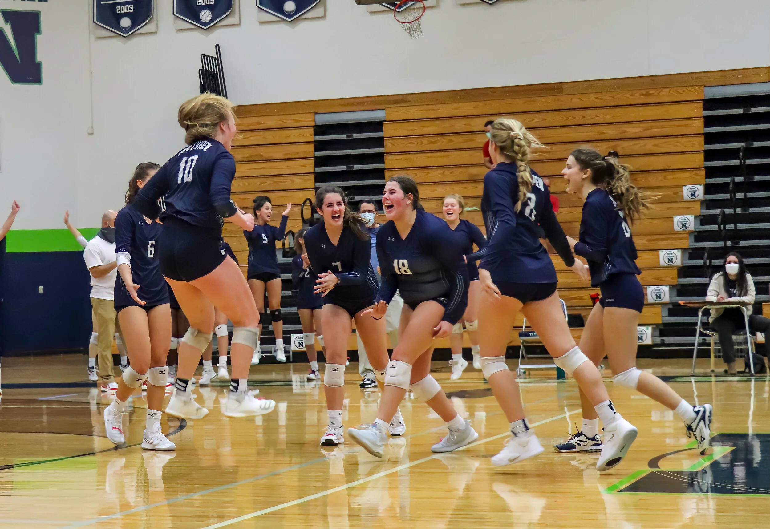 Senior Mallory Free leads the cheers as Northview's Girls Varsity Volleyball scores the final point to win the first playoff game played for the first time in six years.