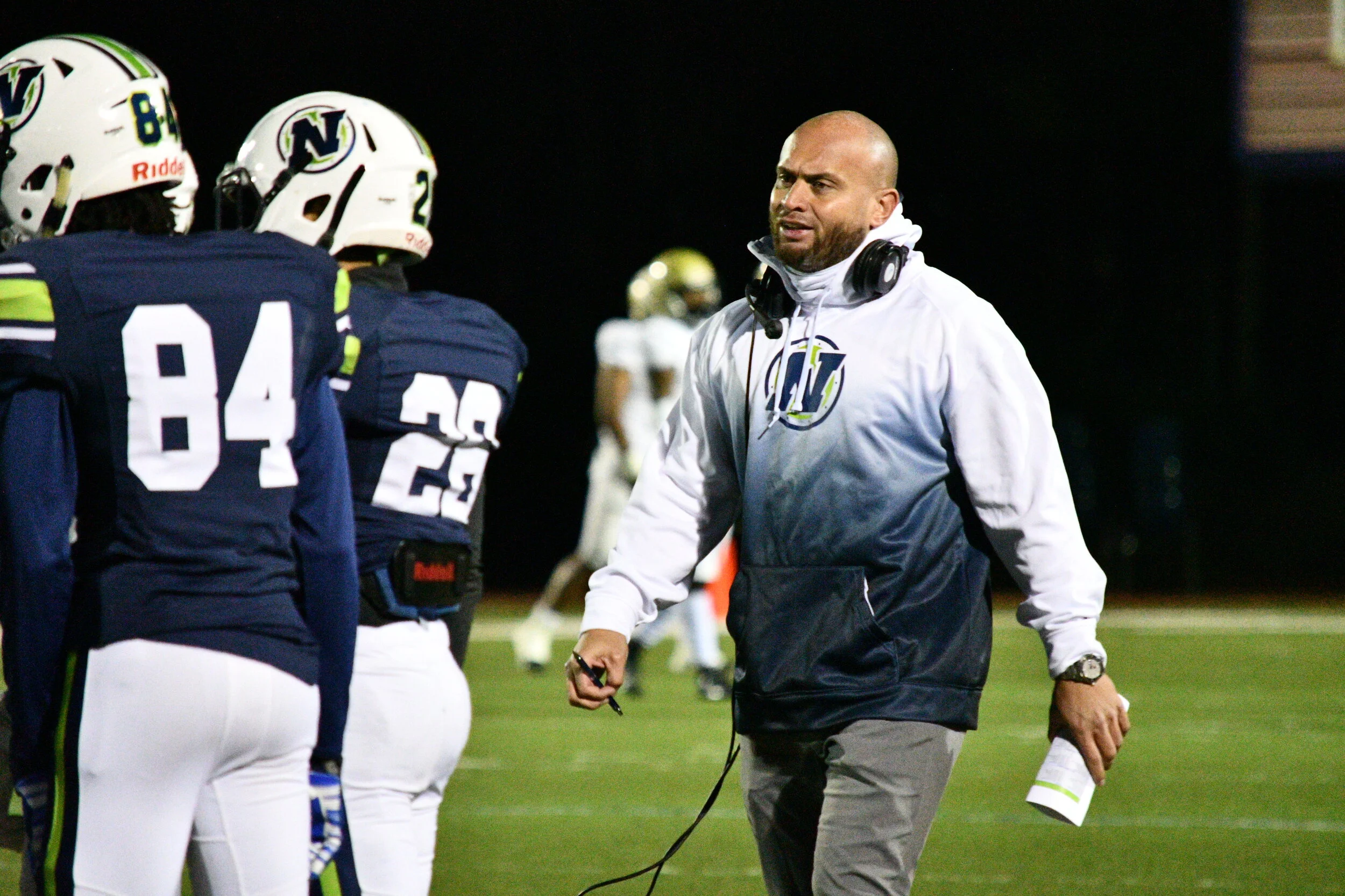 Varsity Football Coach James Thomson walks away frustrated from an argument with a referee.