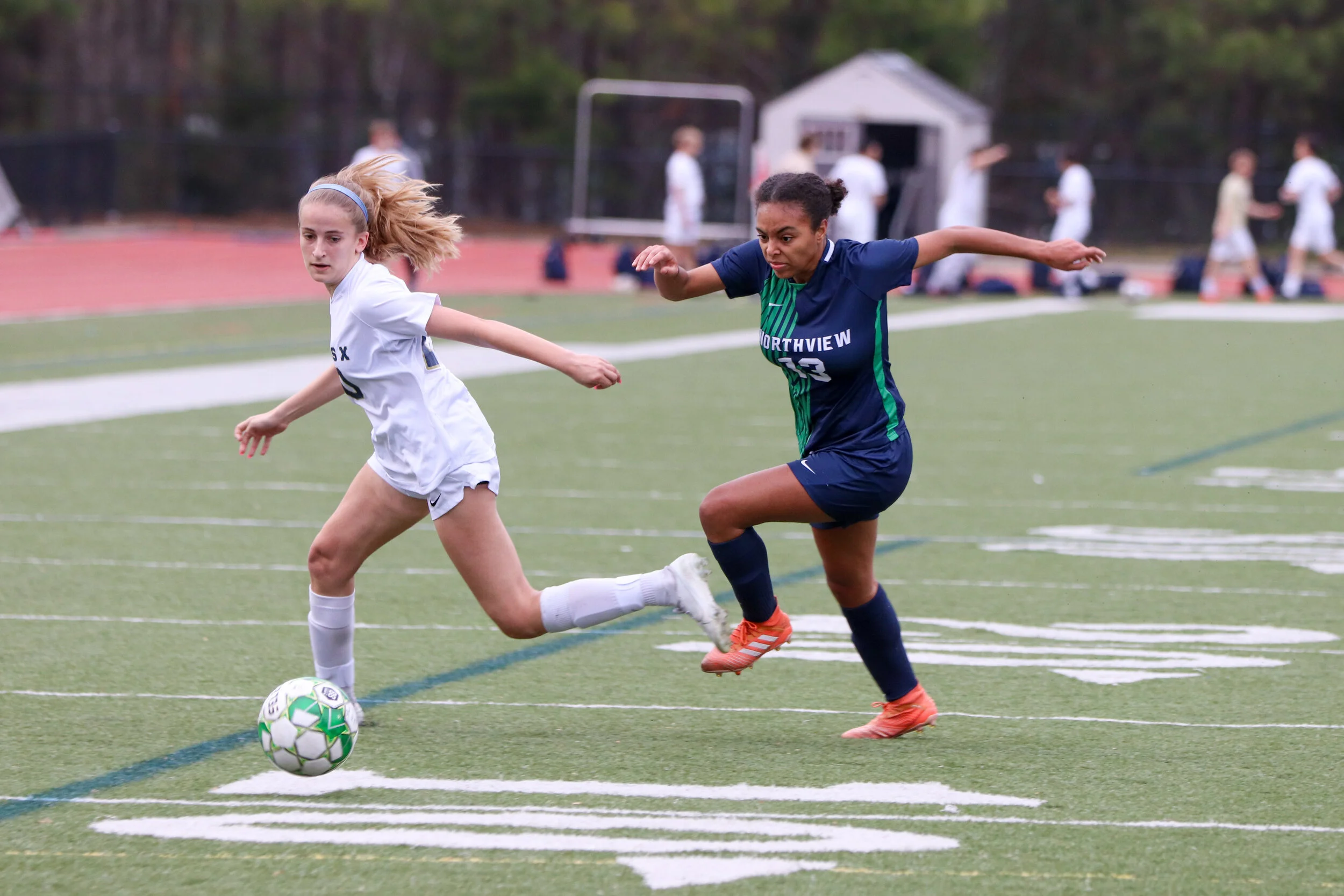 Junior Zoe Russell attempts to outrun the opposing team for the ball.
