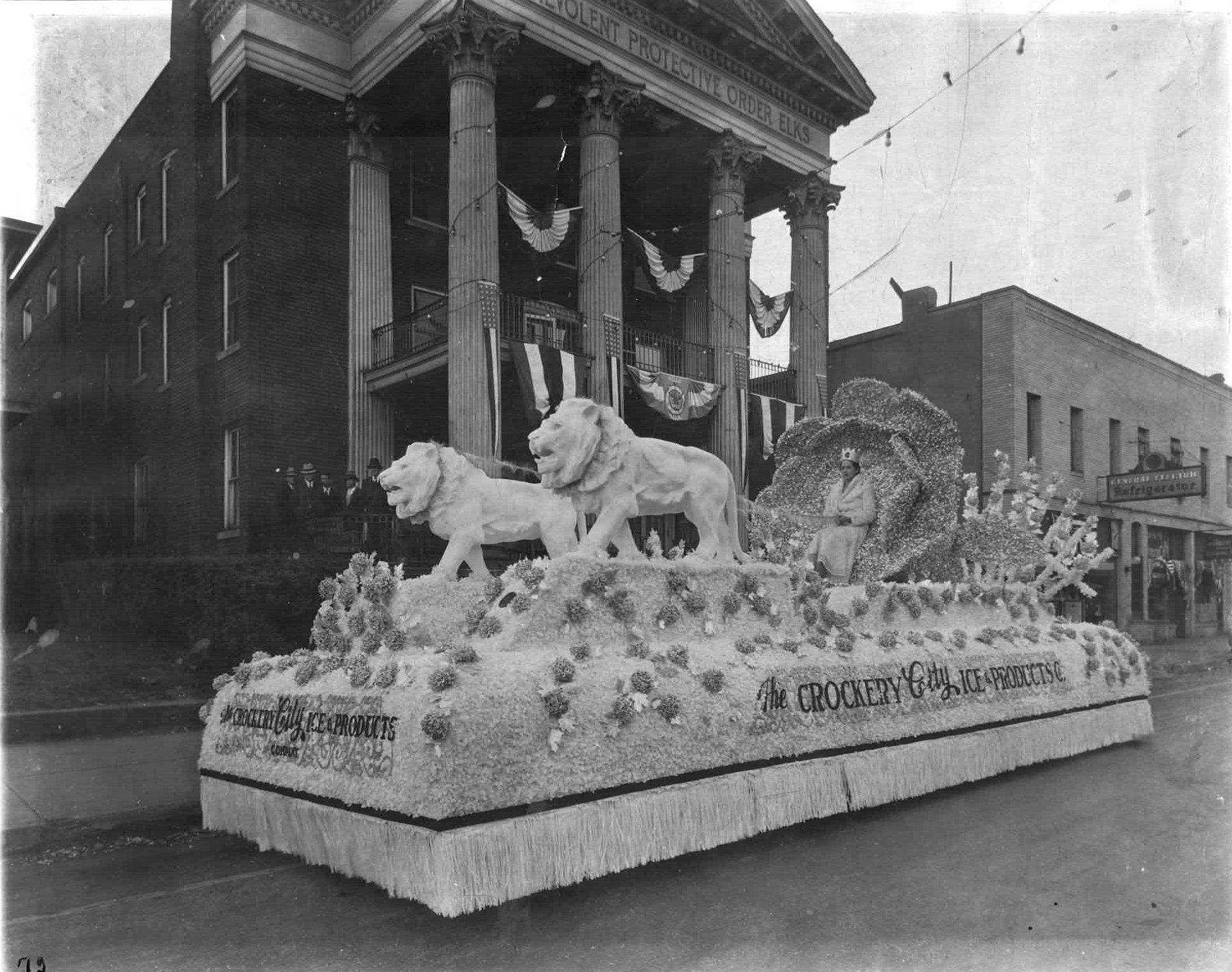 Parade float by The Crockery City Ice & Products Co. in front of the Elks building