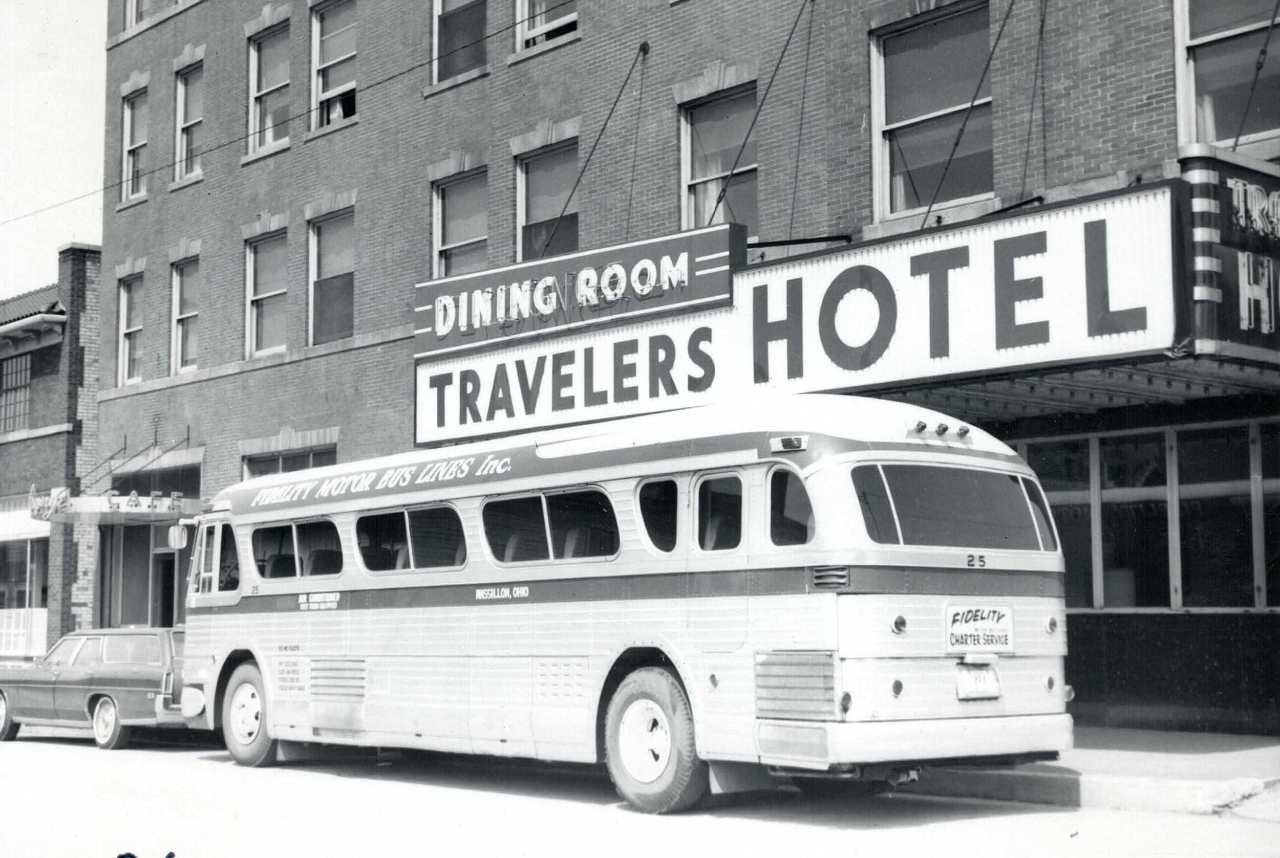Charter bus in front of the Travelers Hotel
