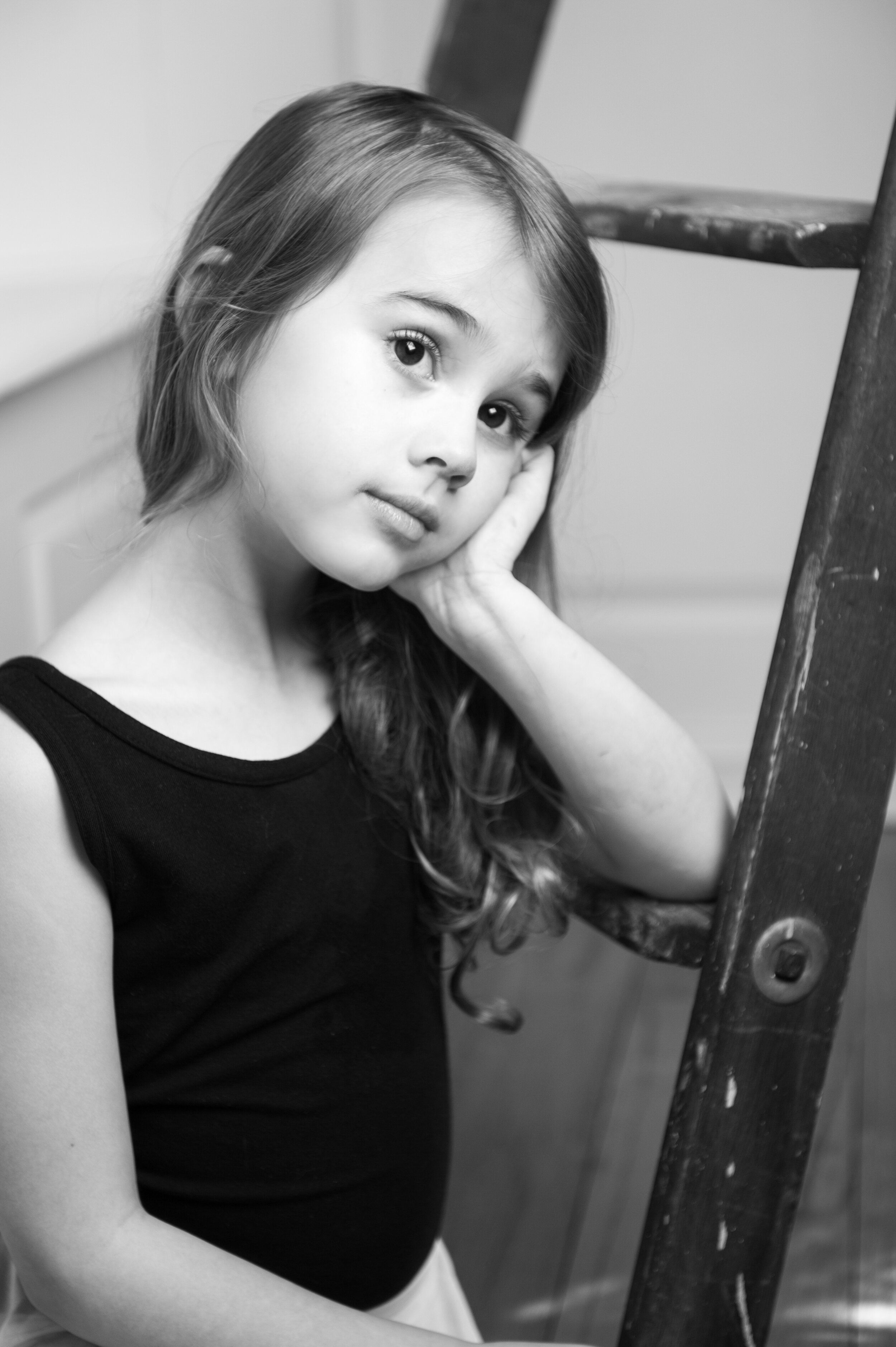 6 year old girl staring dreamily off into the distance