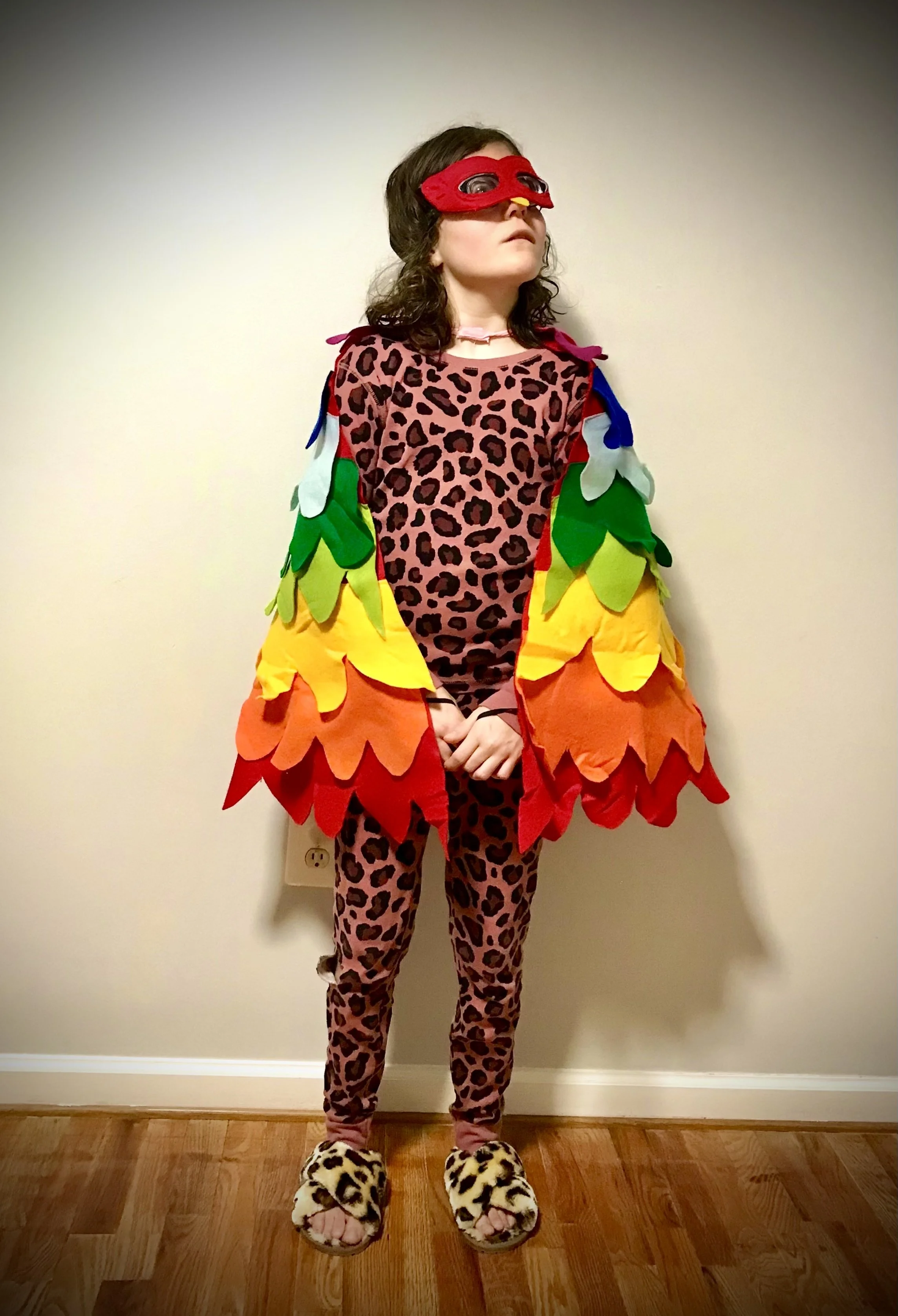 Young girl dressed in a colorful cheetach costume with wings