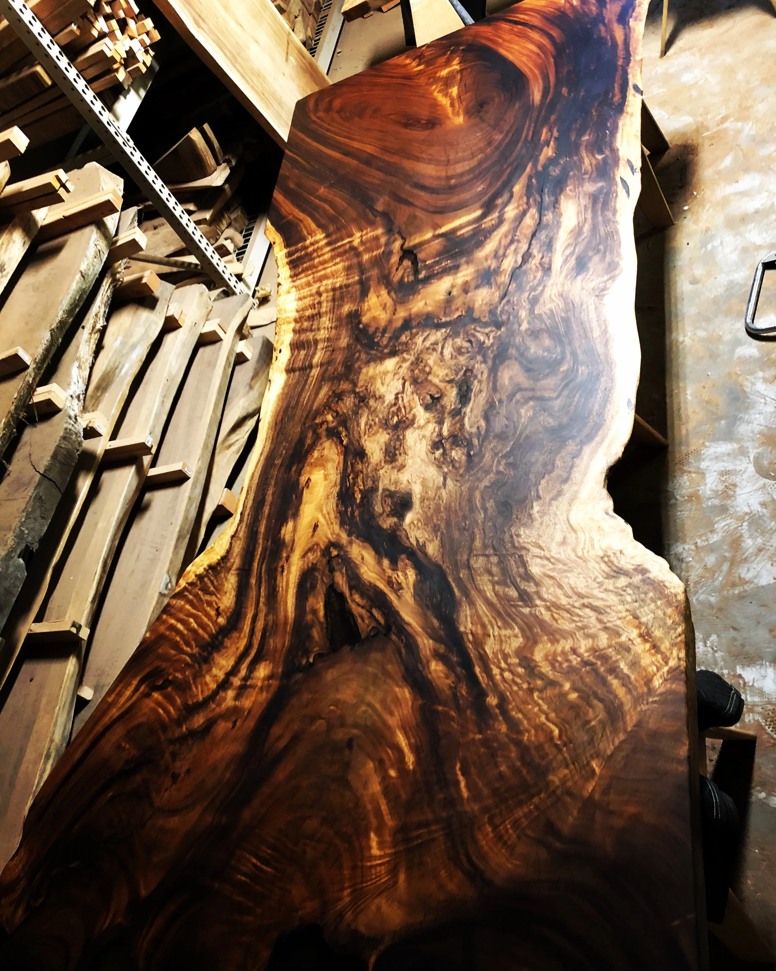 Figured acacia live edge wood slab selected for custom dining table in San Diego.