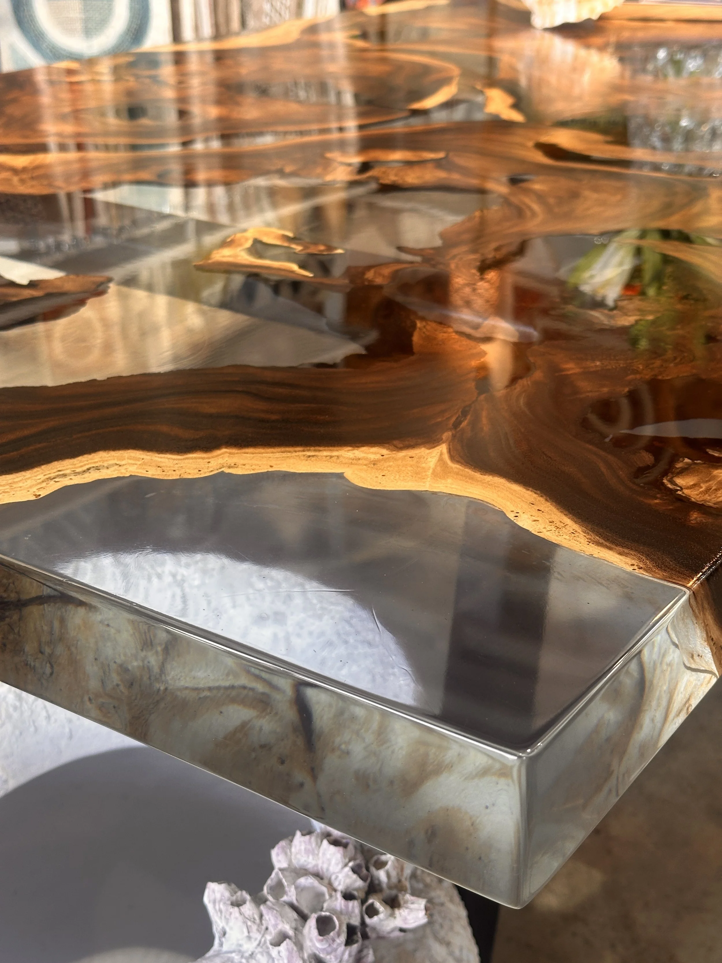 Close-up of a finished live edge wood and clear epoxy resin table handcrafted by Indigenous by La Rue