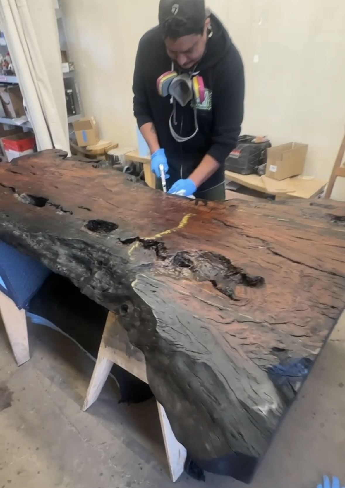Craftsman preparing a live edge wood slab at the Indigenous by La Rue workshop in San Marcos, California