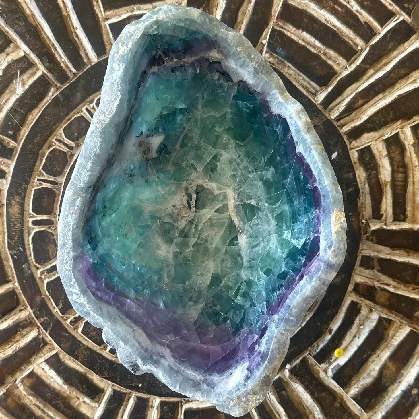 Rainbow Fluorite top view on carving.webp