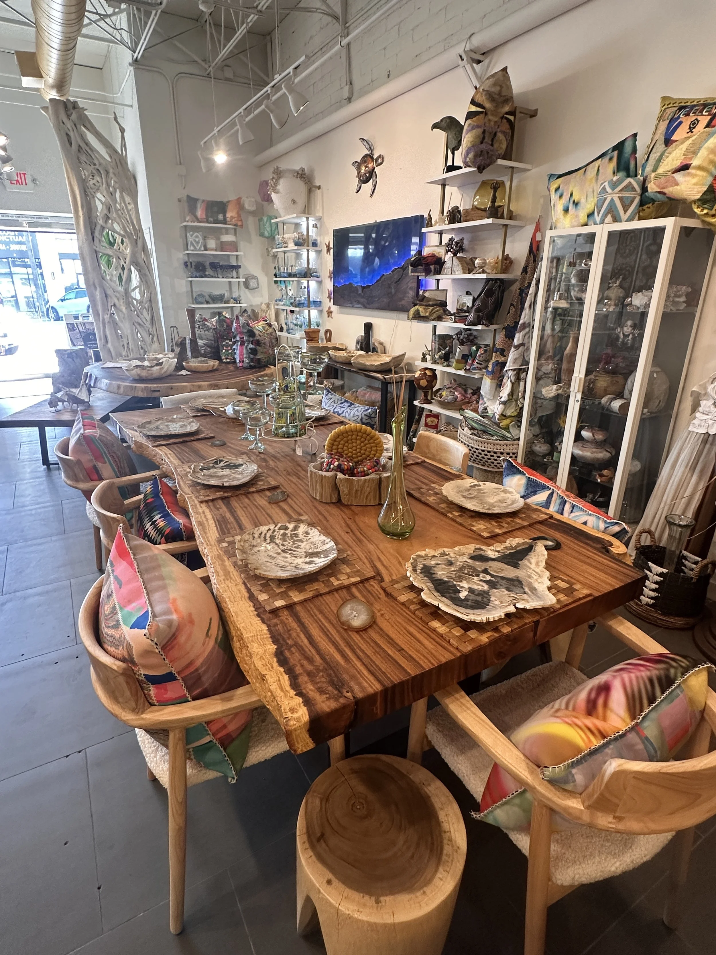 Solid acacia live edge dining table with natural wood grain displayed at Indigenous by La Rue in San Diego, featuring handcrafted luxury furniture.