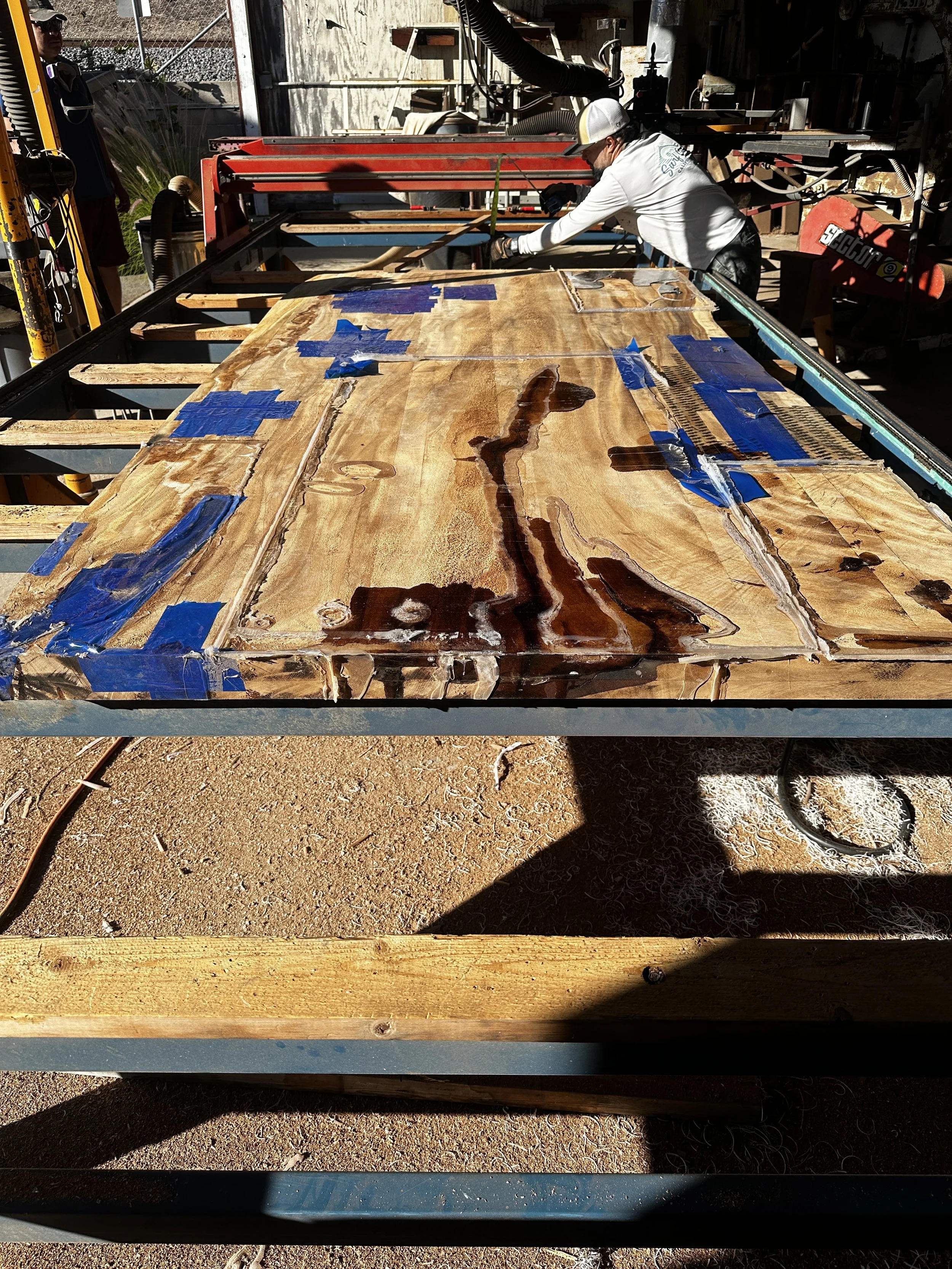 Large live edge wood slab precision flattened on Indigenous by La Rue's 26-foot planer