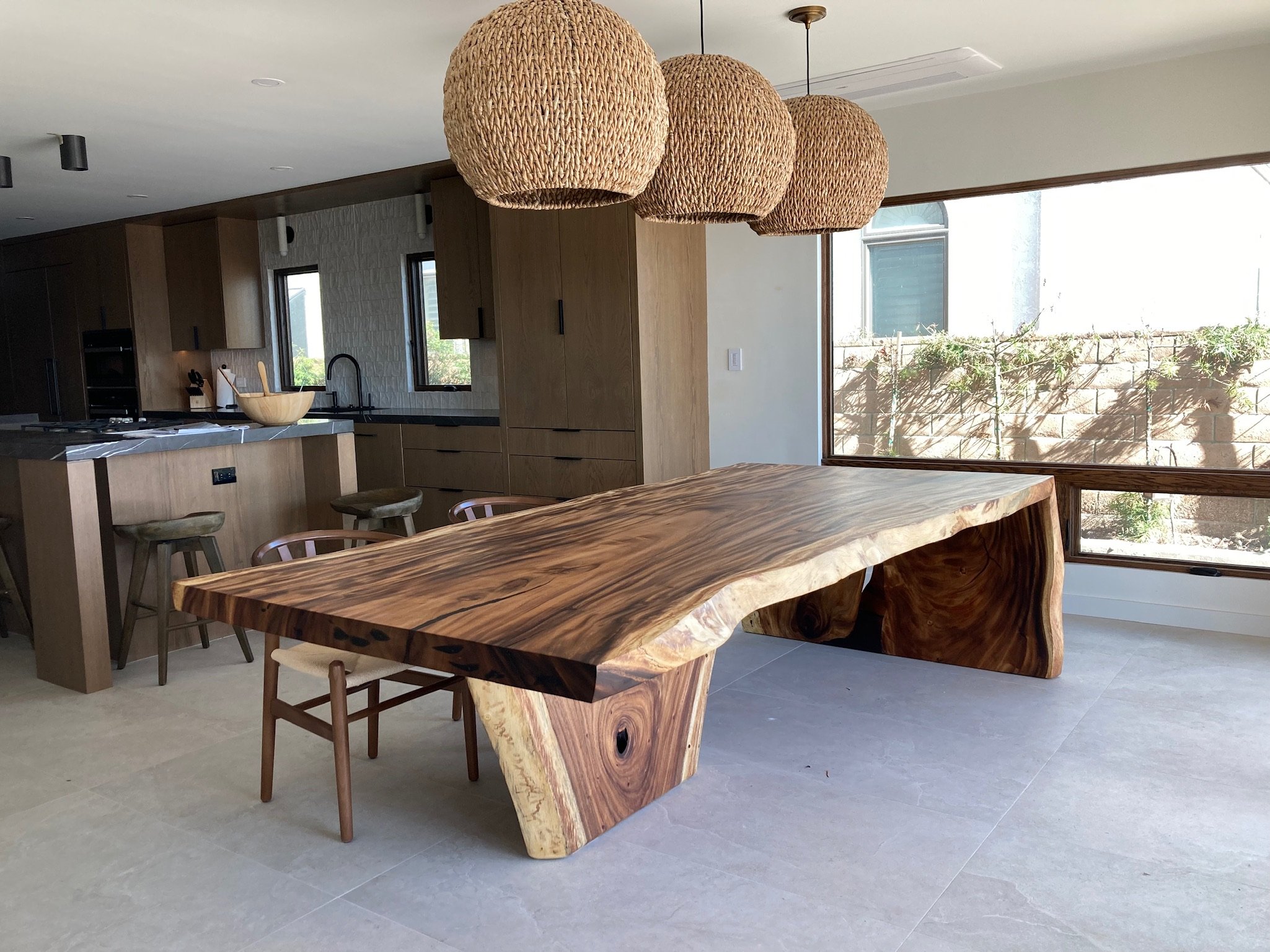 Custom acacia live edge dining table with waterfall base for a Nashville, TN home.