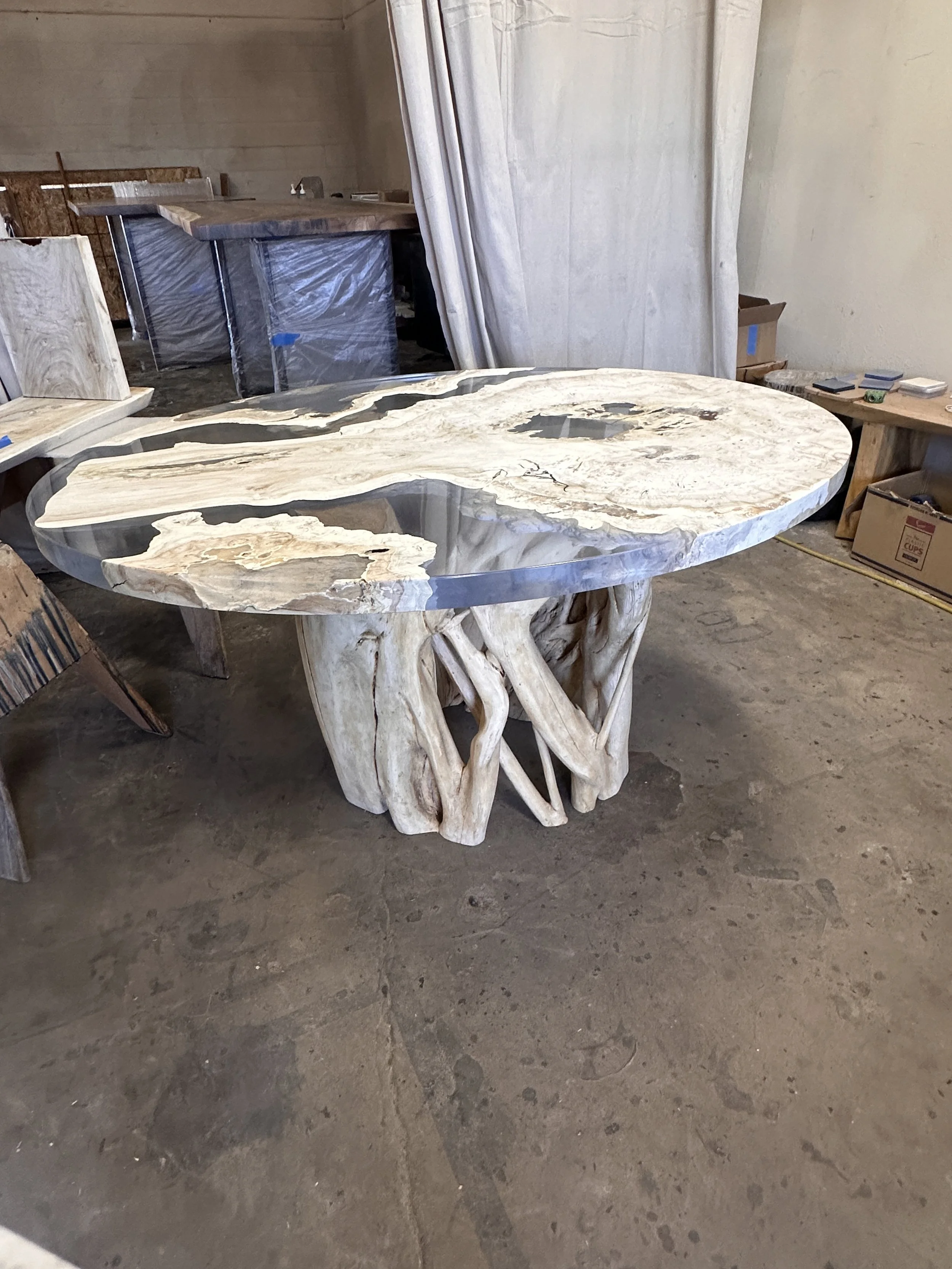Finished live edge resin dining table showing natural wood grain and refined handcrafted surface