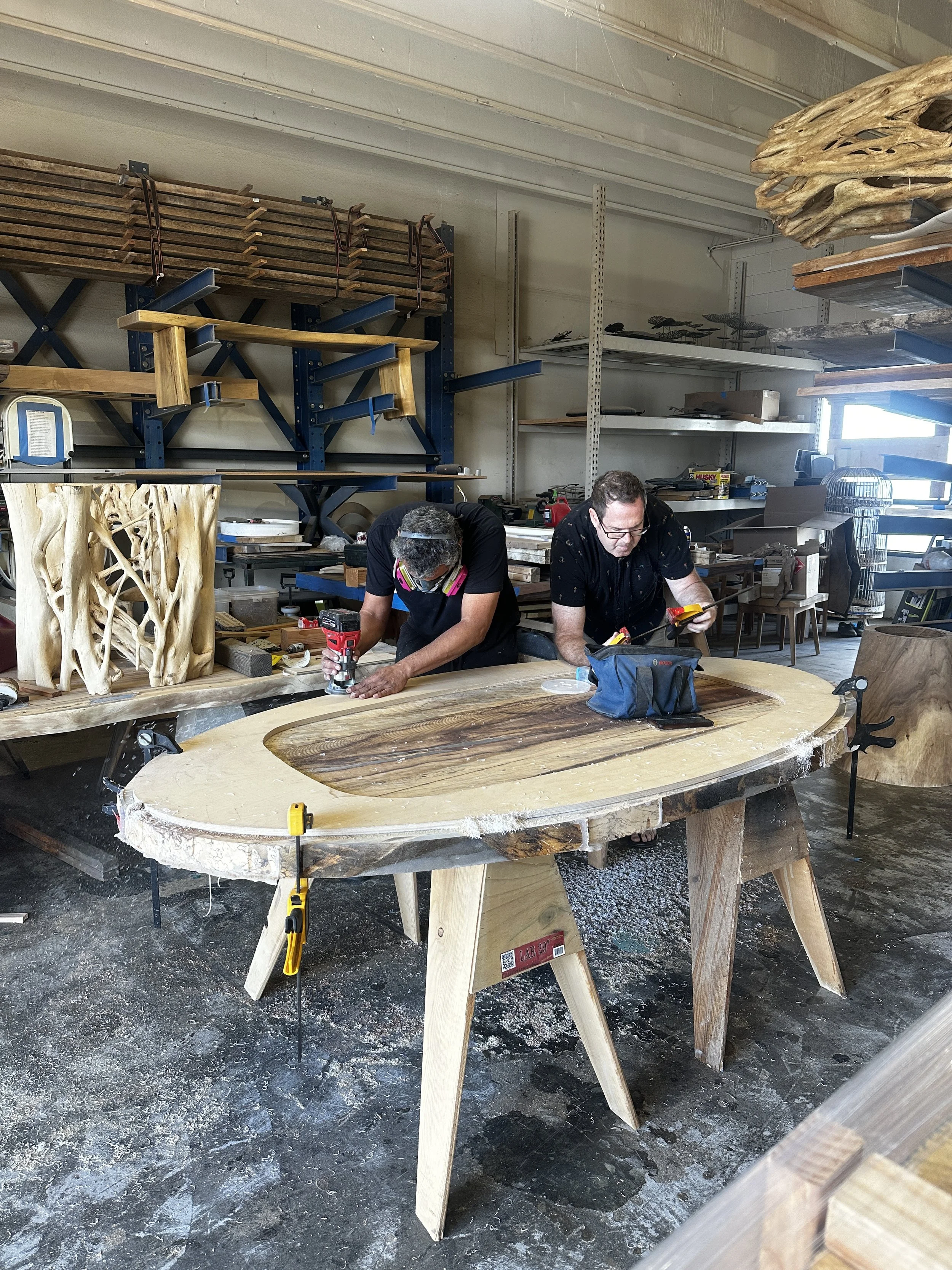 Craftsmen building a custom live edge wood and resin table at the Indigenous by la Rue workshop in San Marcos, CA