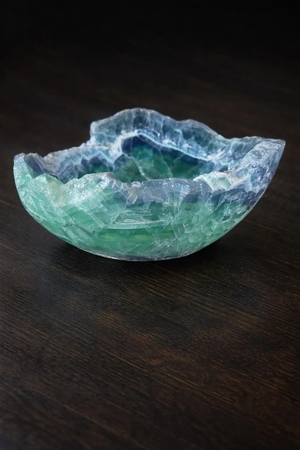 Large fluorite bowl on black table.webp