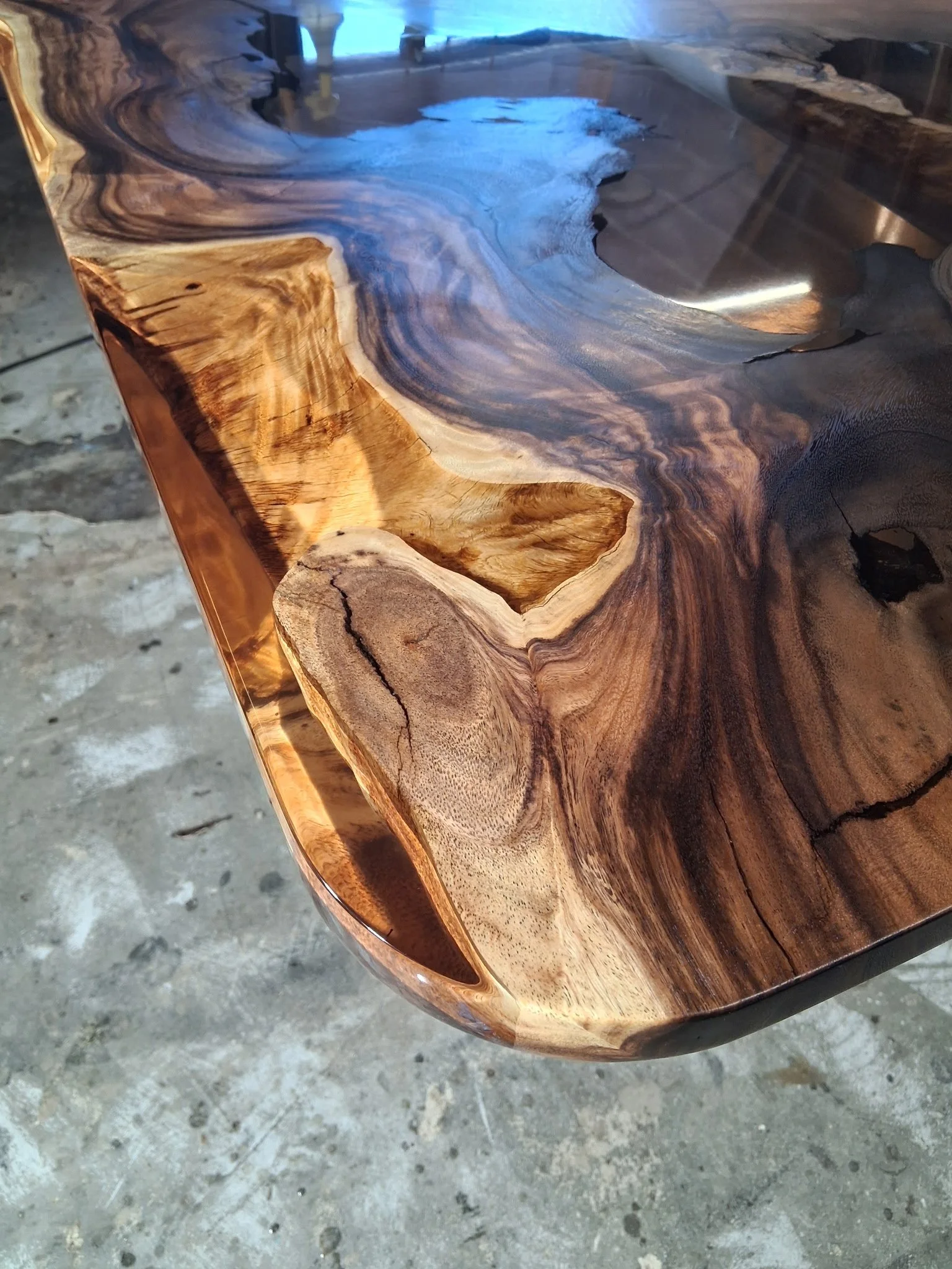 Custom live edge wood and resin dining table handcrafted by Indigenous by La Rue