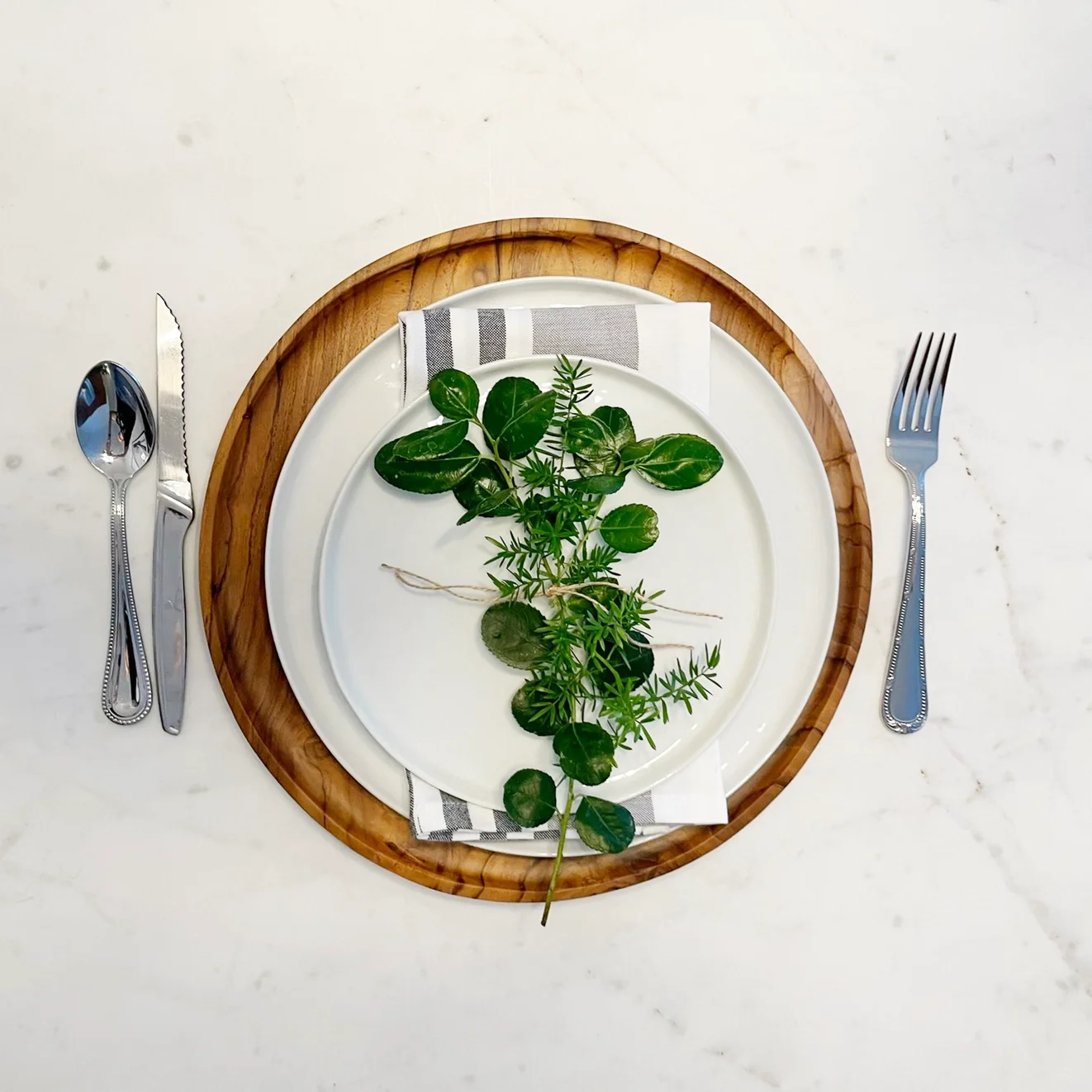 teak charger plate place setting.webp