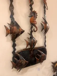 Metal fish on wall.webp