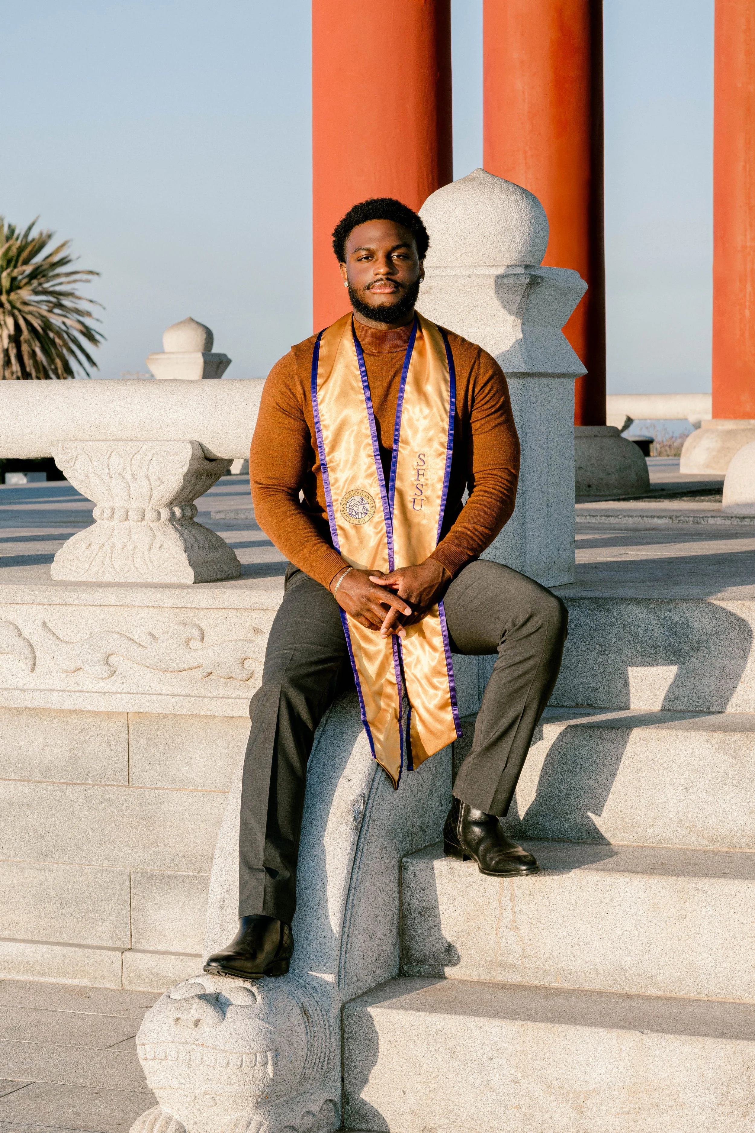 College graduate sits at the Korean Friendship Bell during sunset in San Pedro, California.jpg