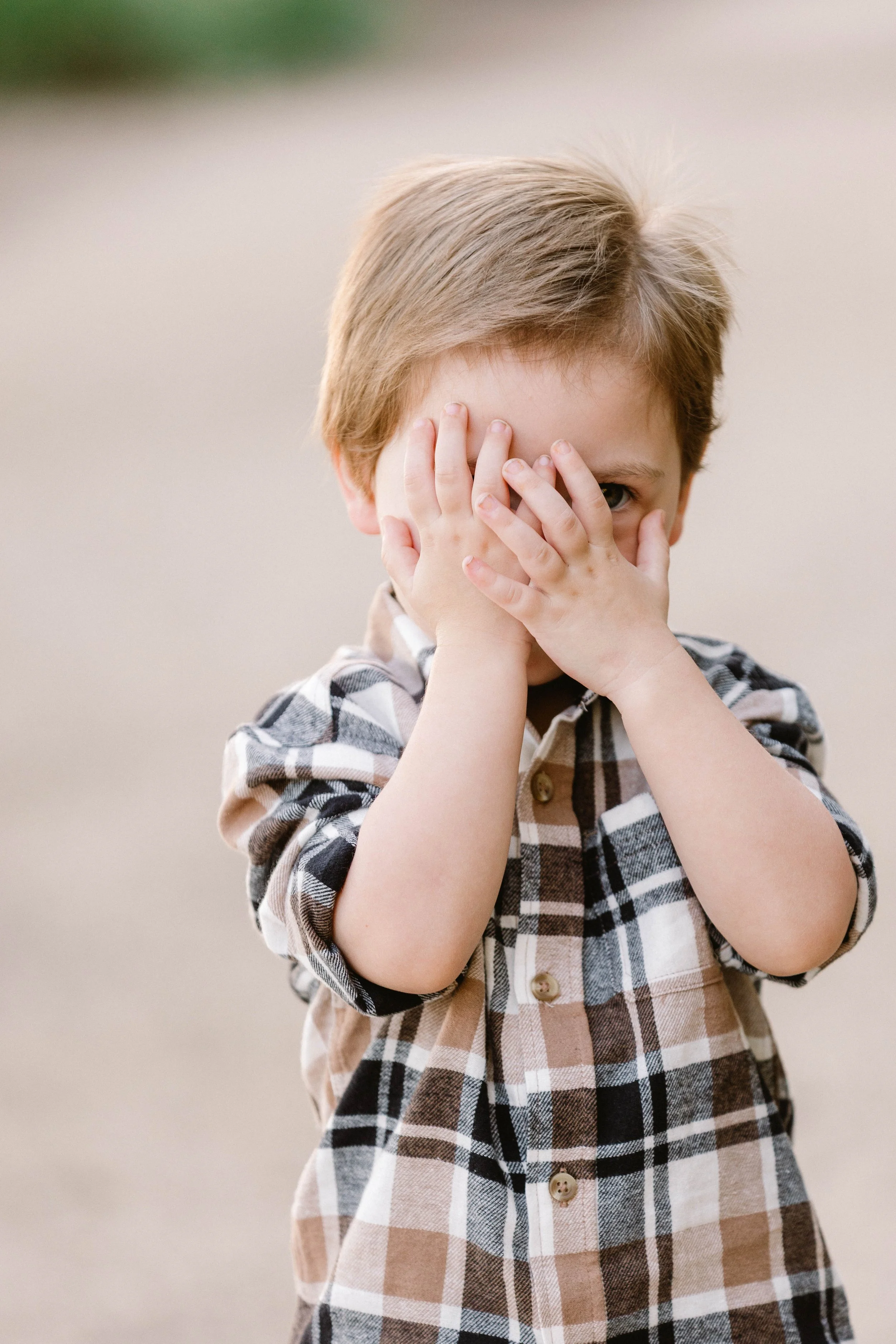 Child plays peek-a-boo
