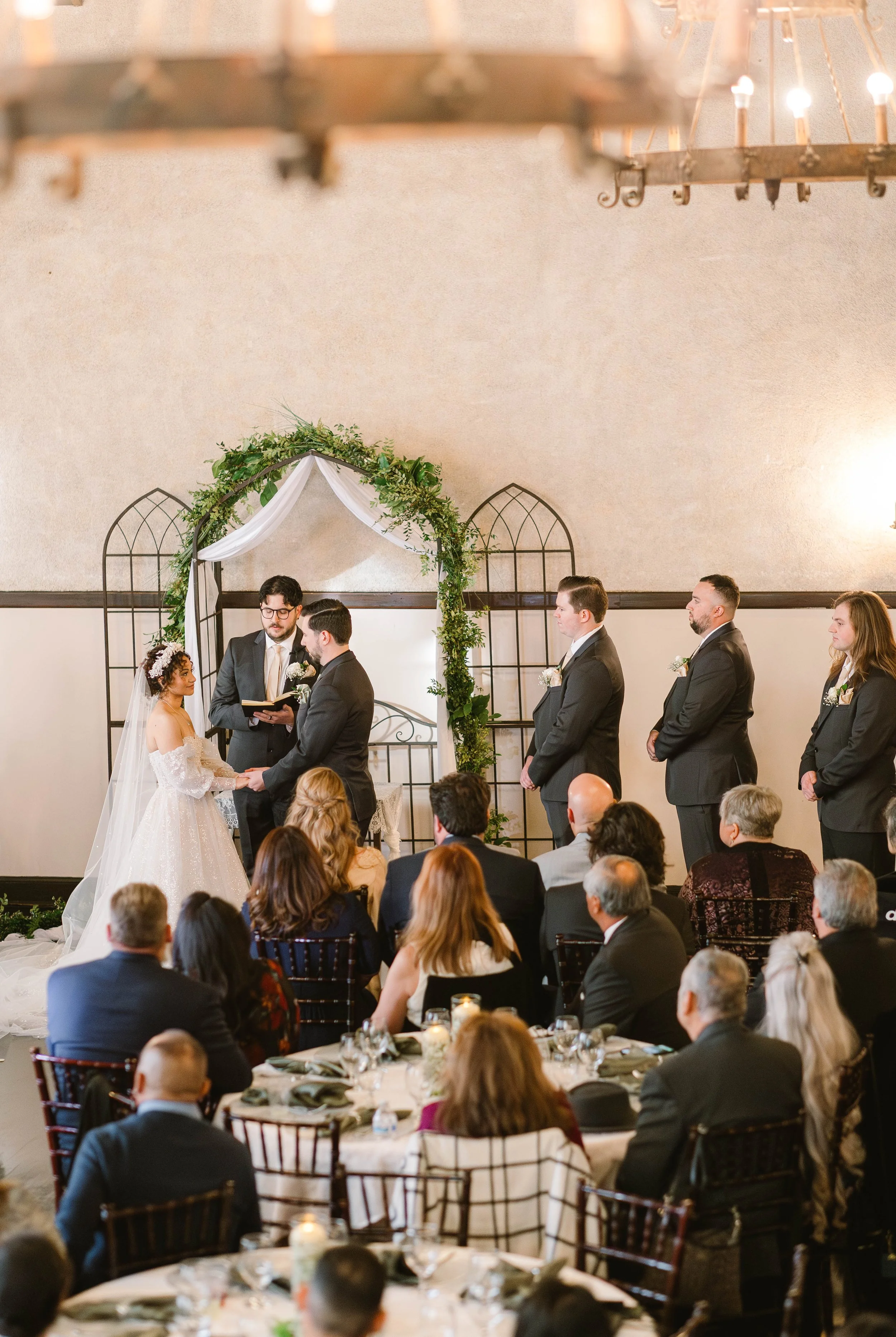 Bride and groom stand at archway inside the historic Loft 84 event venue in Riverside California