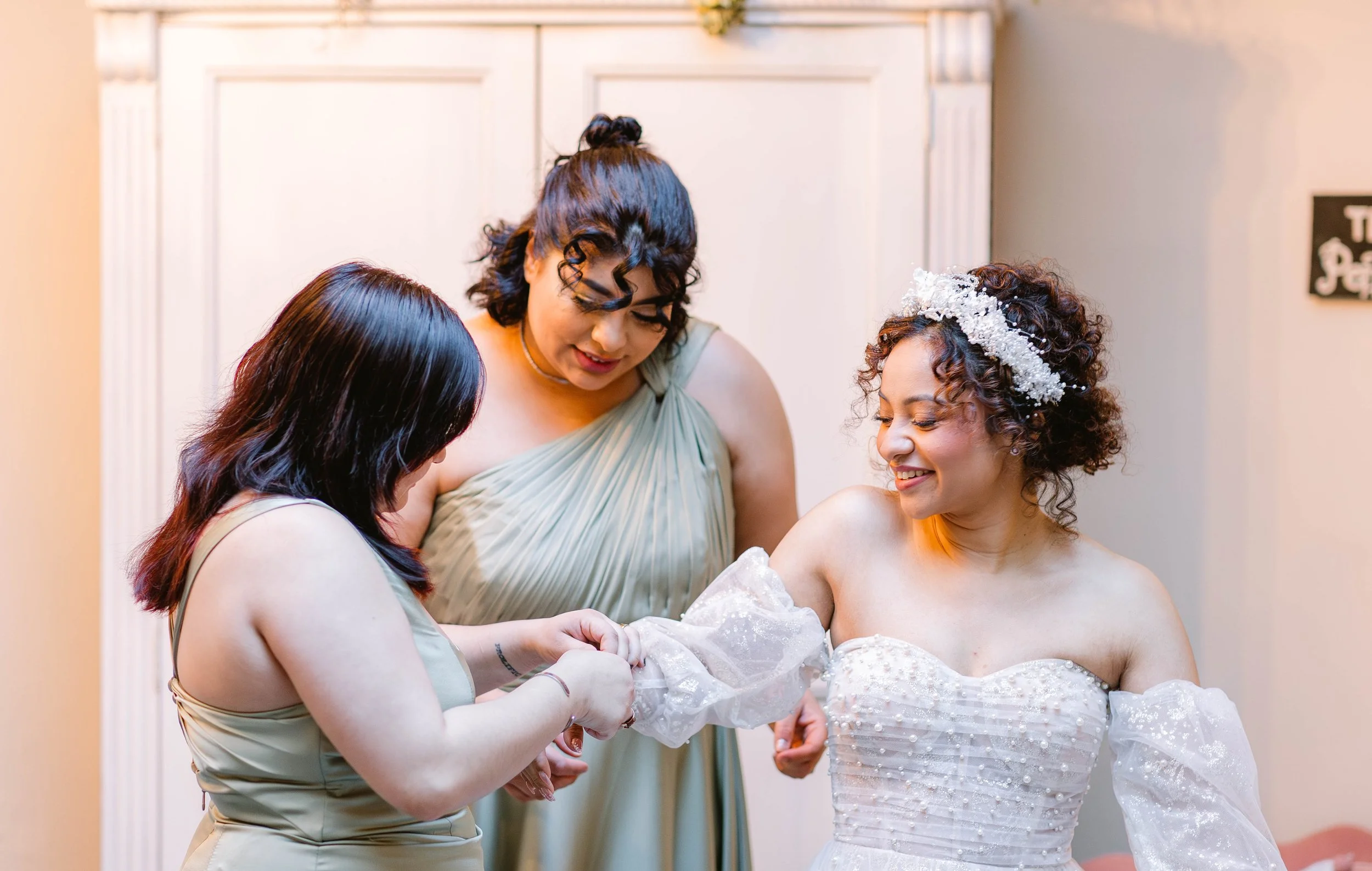 loft-84-wedding-bridesmaids-helping-bride-get-dressed.jpg