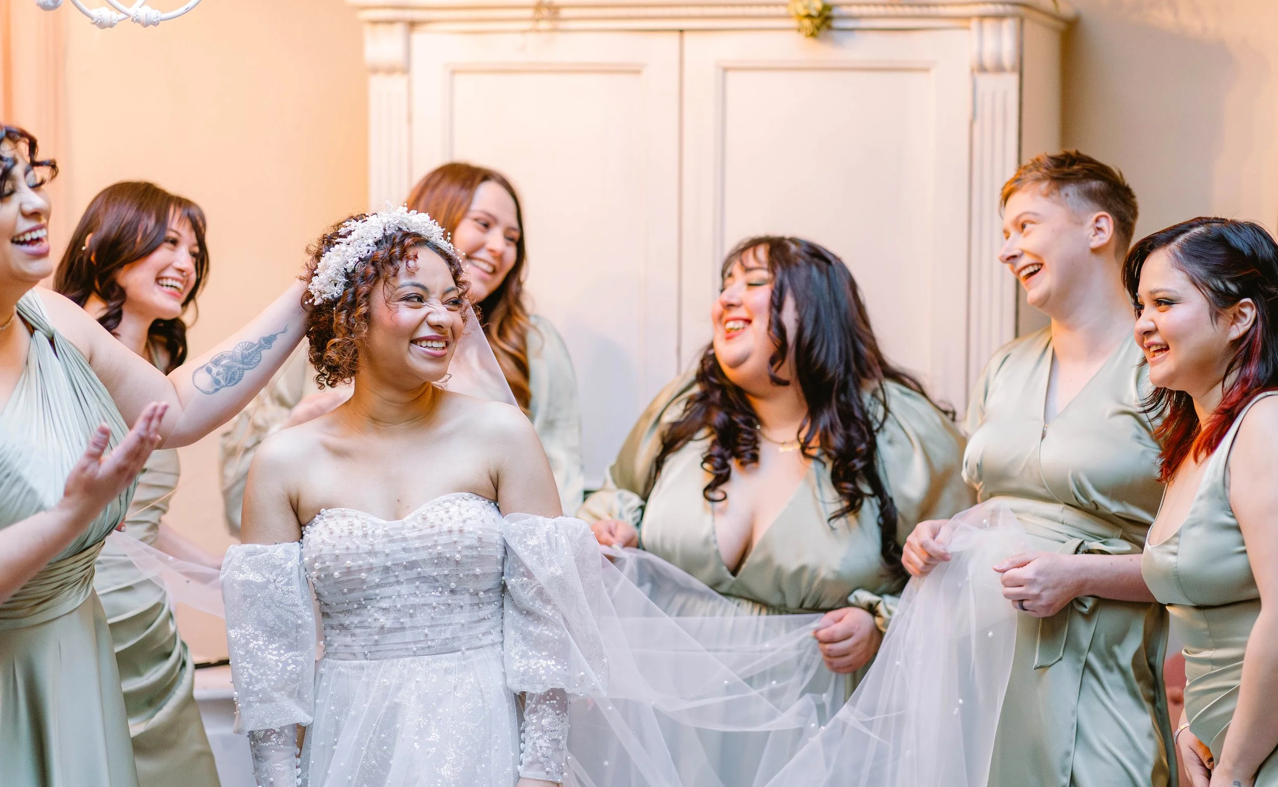 bride-getting-ready-with-bridesmaids-laughing-candid.jpg