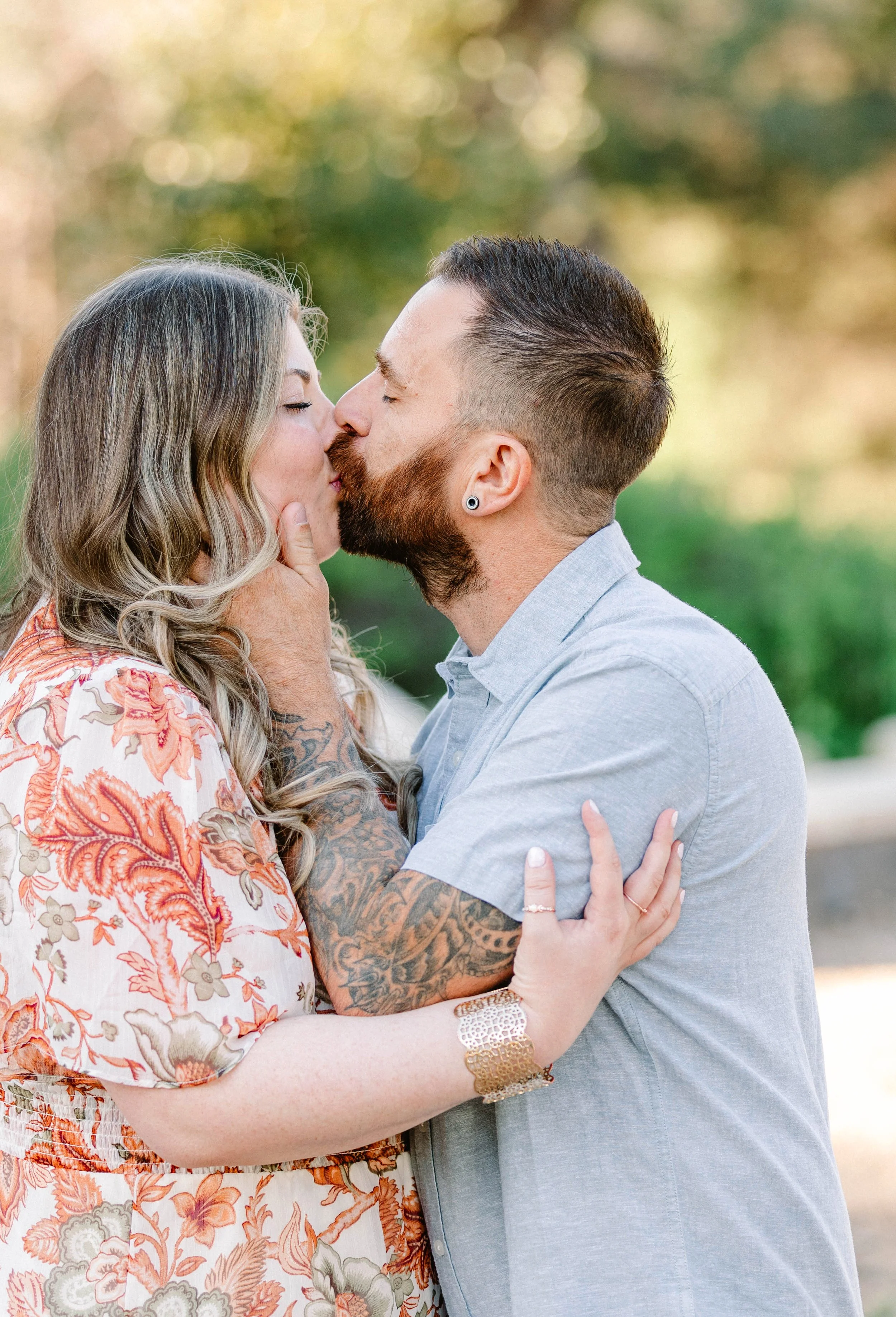 Couple shares a kiss surrounded by lush greenery, Pasadena, California