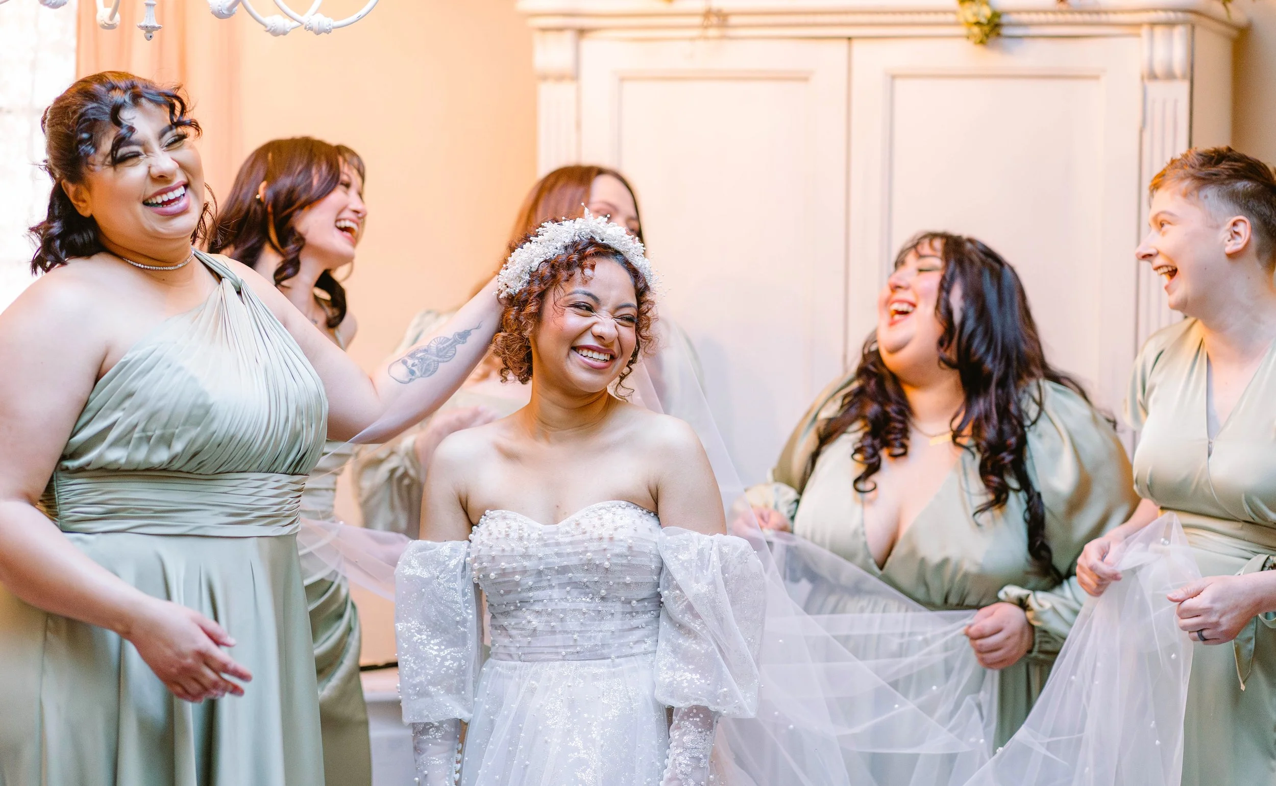 bride-getting-ready-with-bridesmaids-laughing-candid.jpg