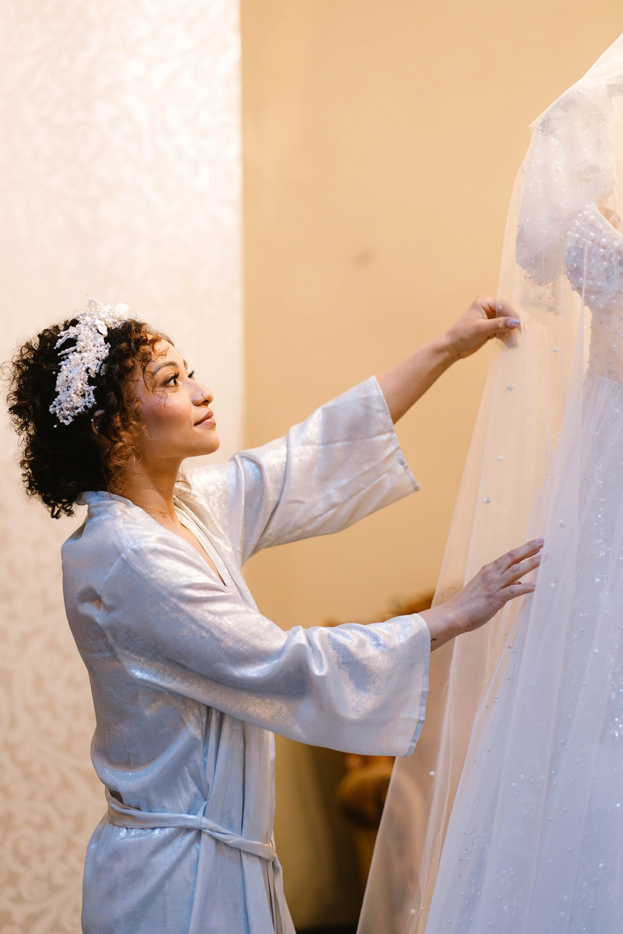 bride-getting-ready-with-wedding-dress-detail.jpg
