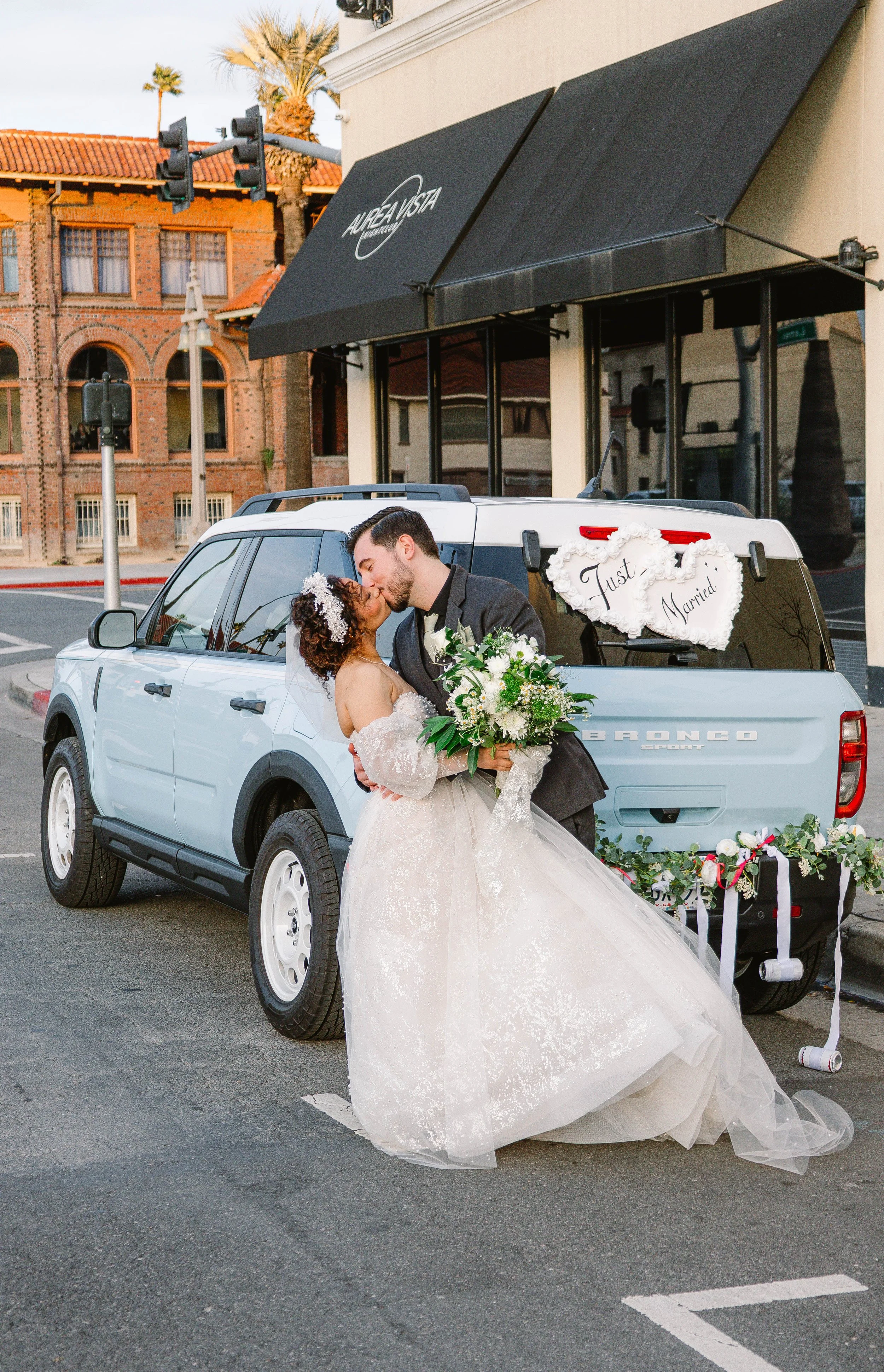 downtown-riverside-wedding-couple-kiss-by-car.jpg