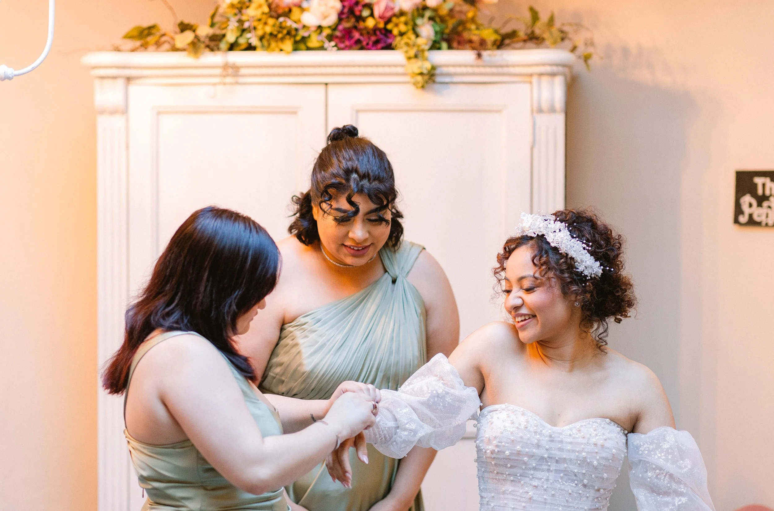 loft-84-wedding-bridesmaids-helping-bride-get-dressed.jpg
