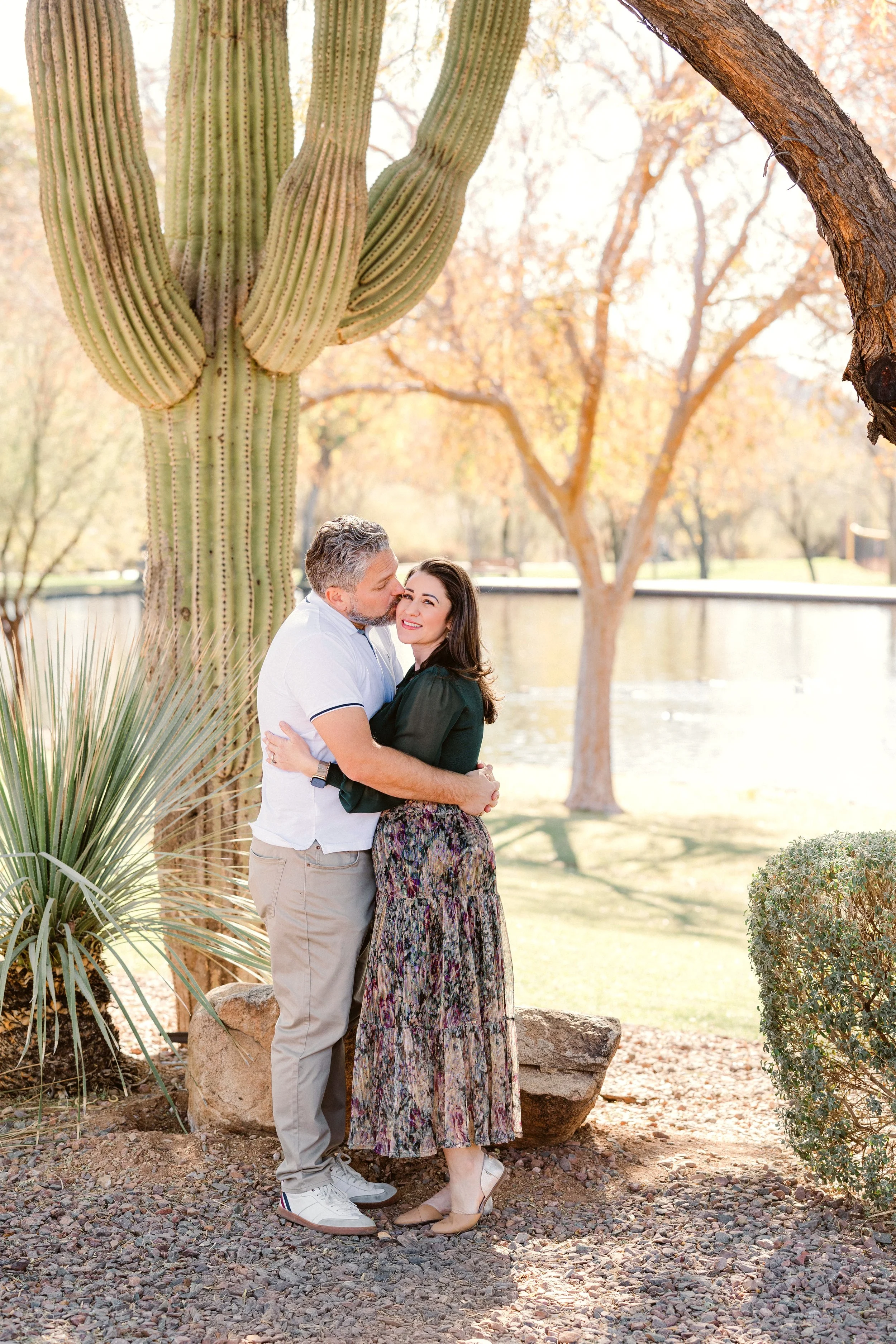 anthem-arizona-family-session-parents-embrace-near-cactus.jpg