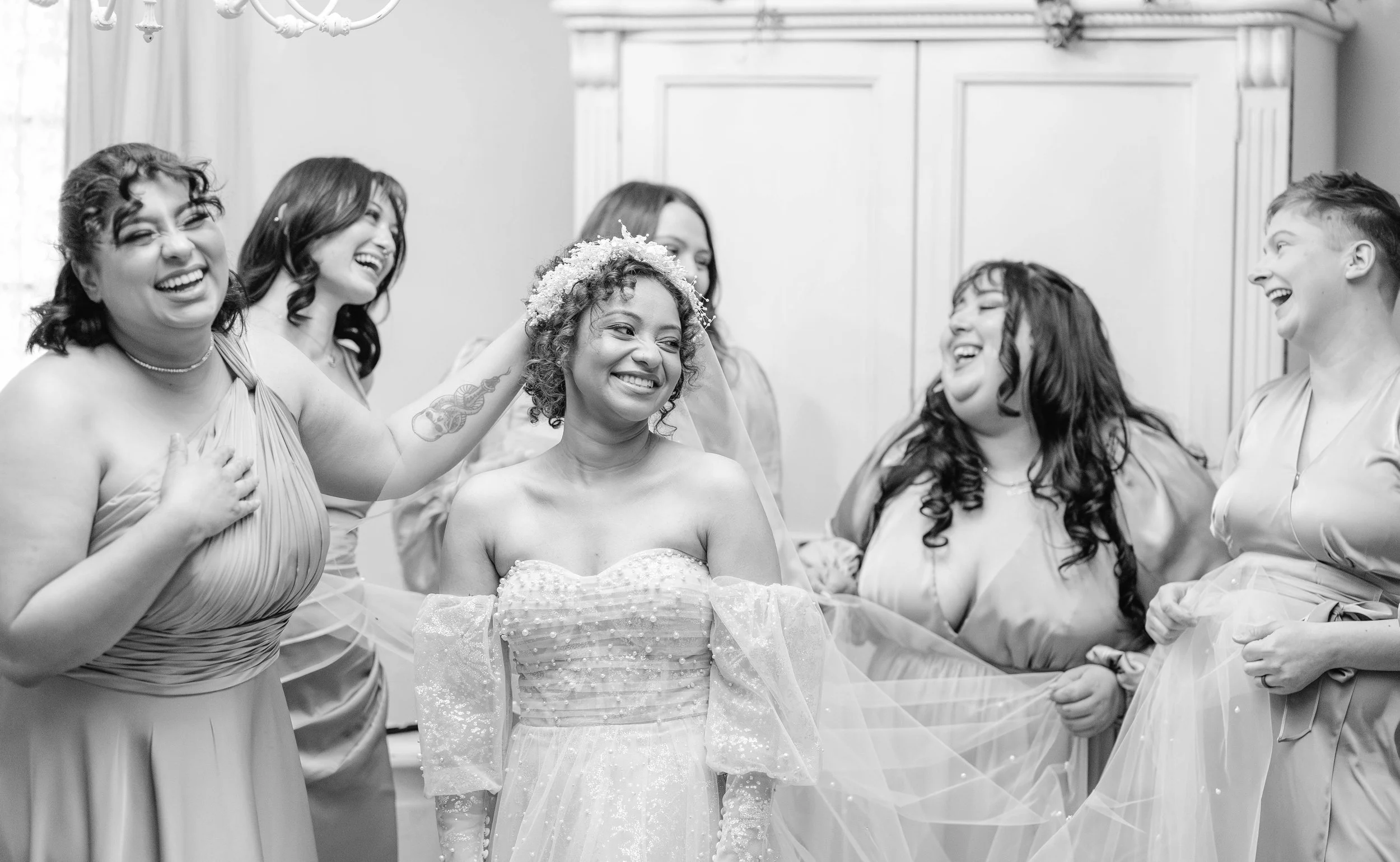 bride-getting-ready-with-bridesmaids-laughing-candid.jpg