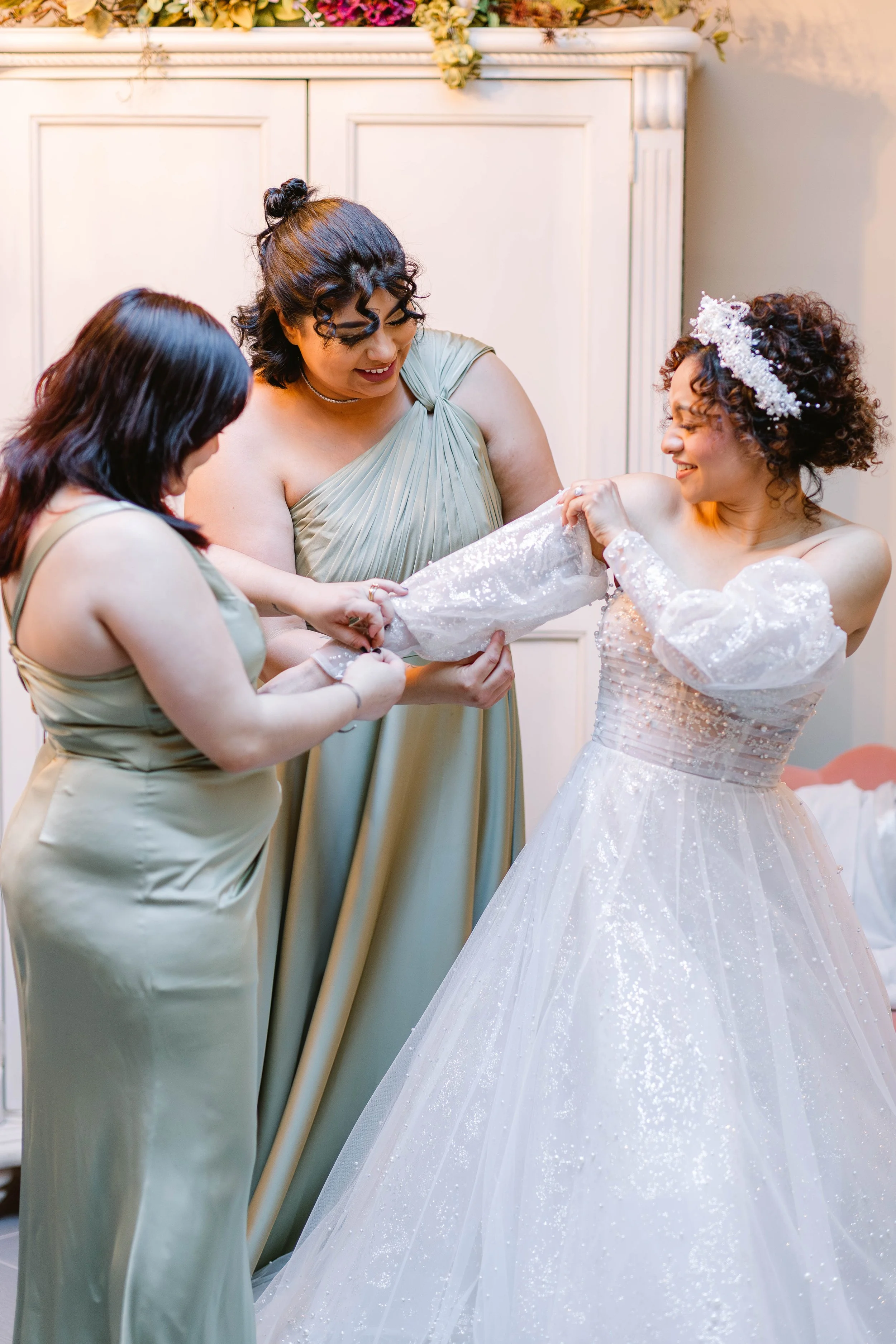 loft-84-wedding-bridesmaids-helping-bride-get-dressed.jpg
