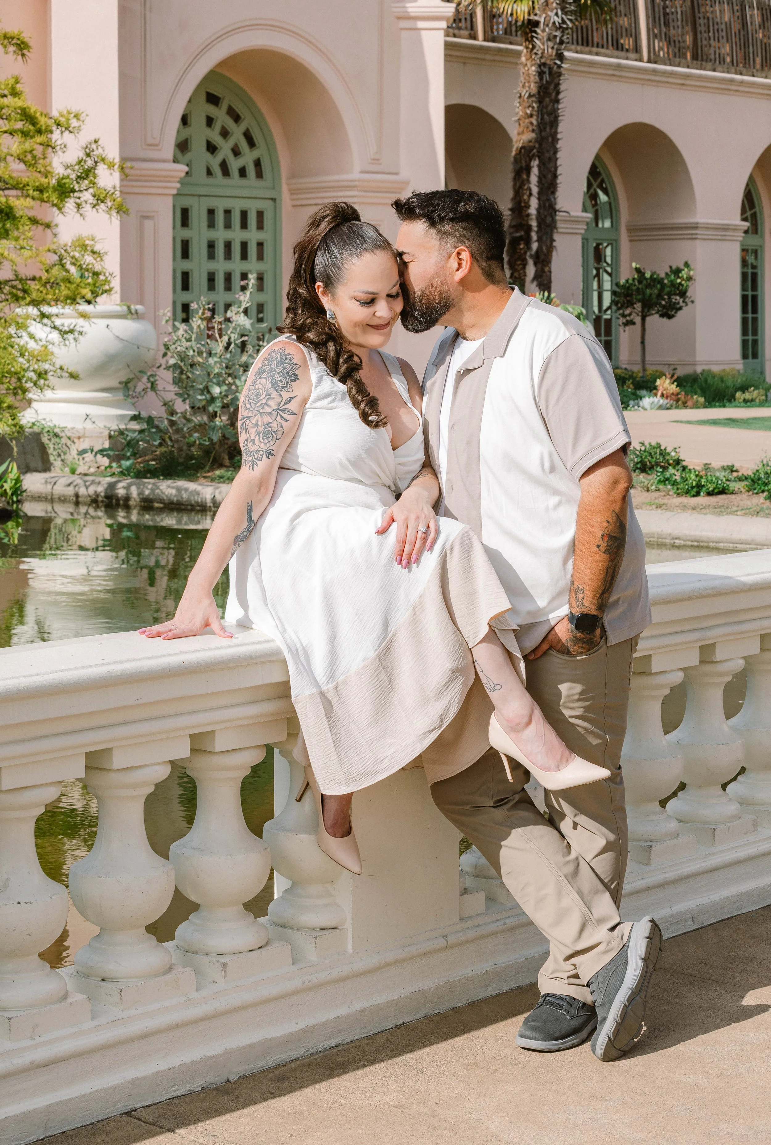Couple shares sweet moment on bridge overlooking koi pond, Balboa Park San Diego