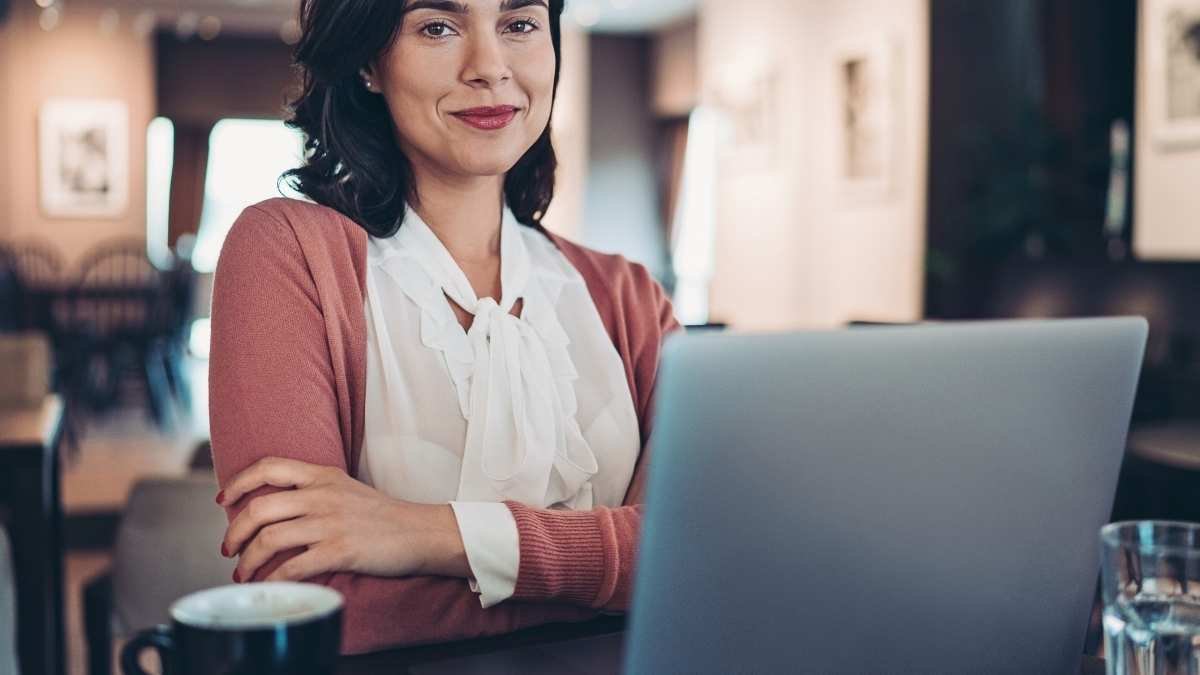 Woman looking confidently ahead behind computer, symbolizing high achievers rebuilding their self-worth