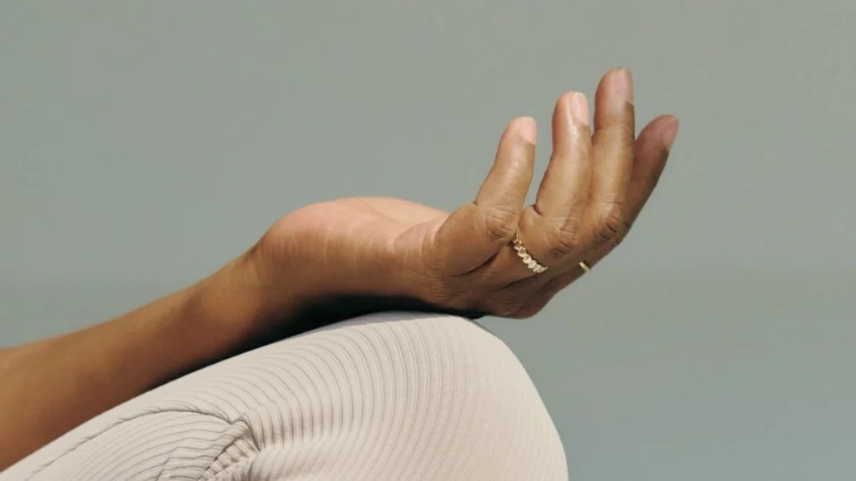 Person resting with one hand raised in a relaxed position