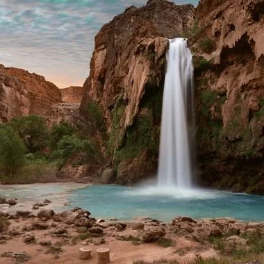 Arizona w aterfall flowing into a turquoise pool in a rocky canyon