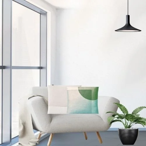 Modern living room with a white sofa, decorative pillows, a black pendant light, large glass door, and a potted plant.