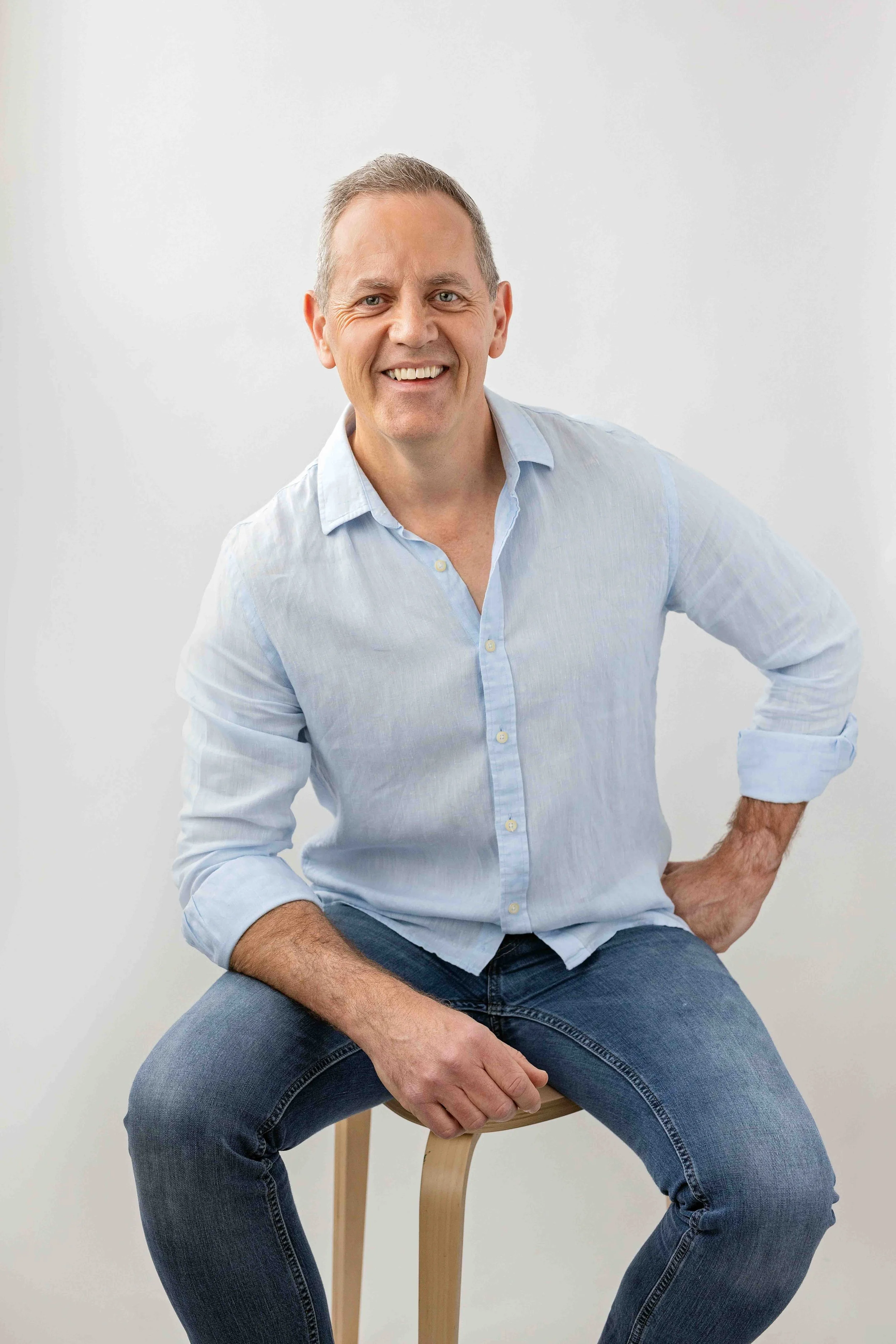 happy headshot of a man in a relaxed studio setting