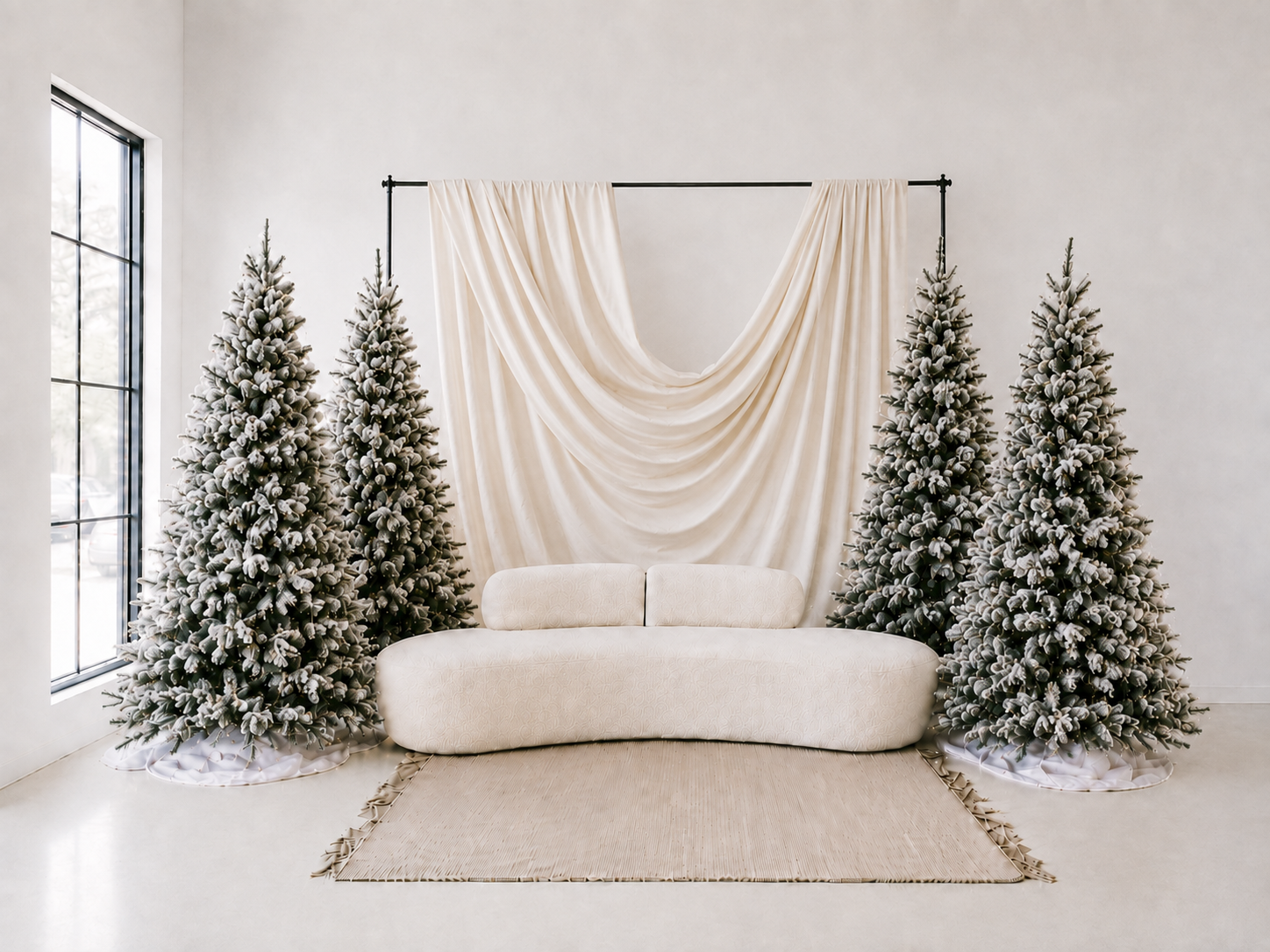 A holiday portrait set inside Lux Rae Loft’s Grand Studio featuring an evergreen Christmas tree, greenery-draped fireplace and warm natural light. The studio is available for photography studio rentals near Vancouver WA and Portland OR.