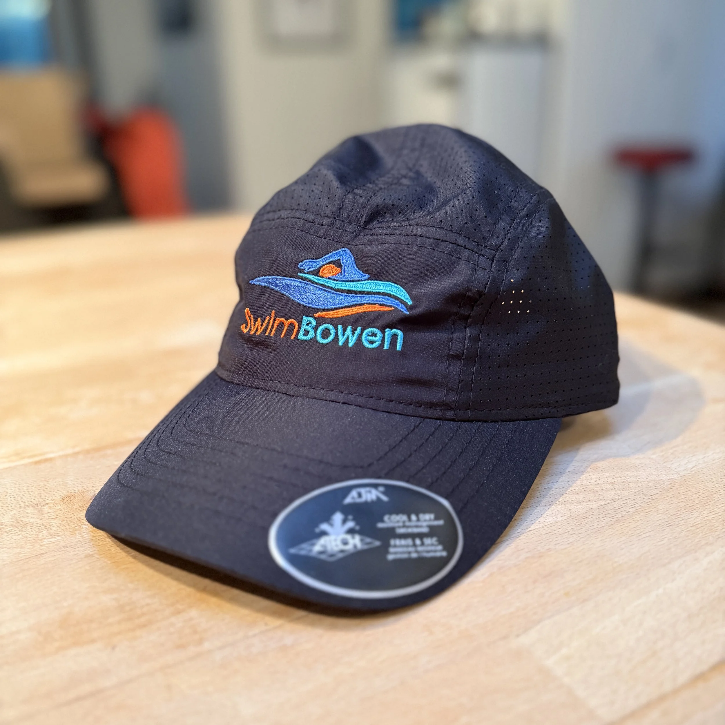 SwimBowen branded cap.