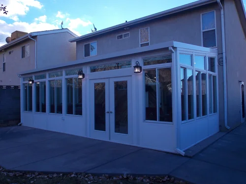 A folding patio door with three lanterns glowing.