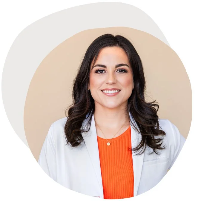 Headshot of Dr. Jamie Rodriguez, wearing an orange shirt and white doctor coat.