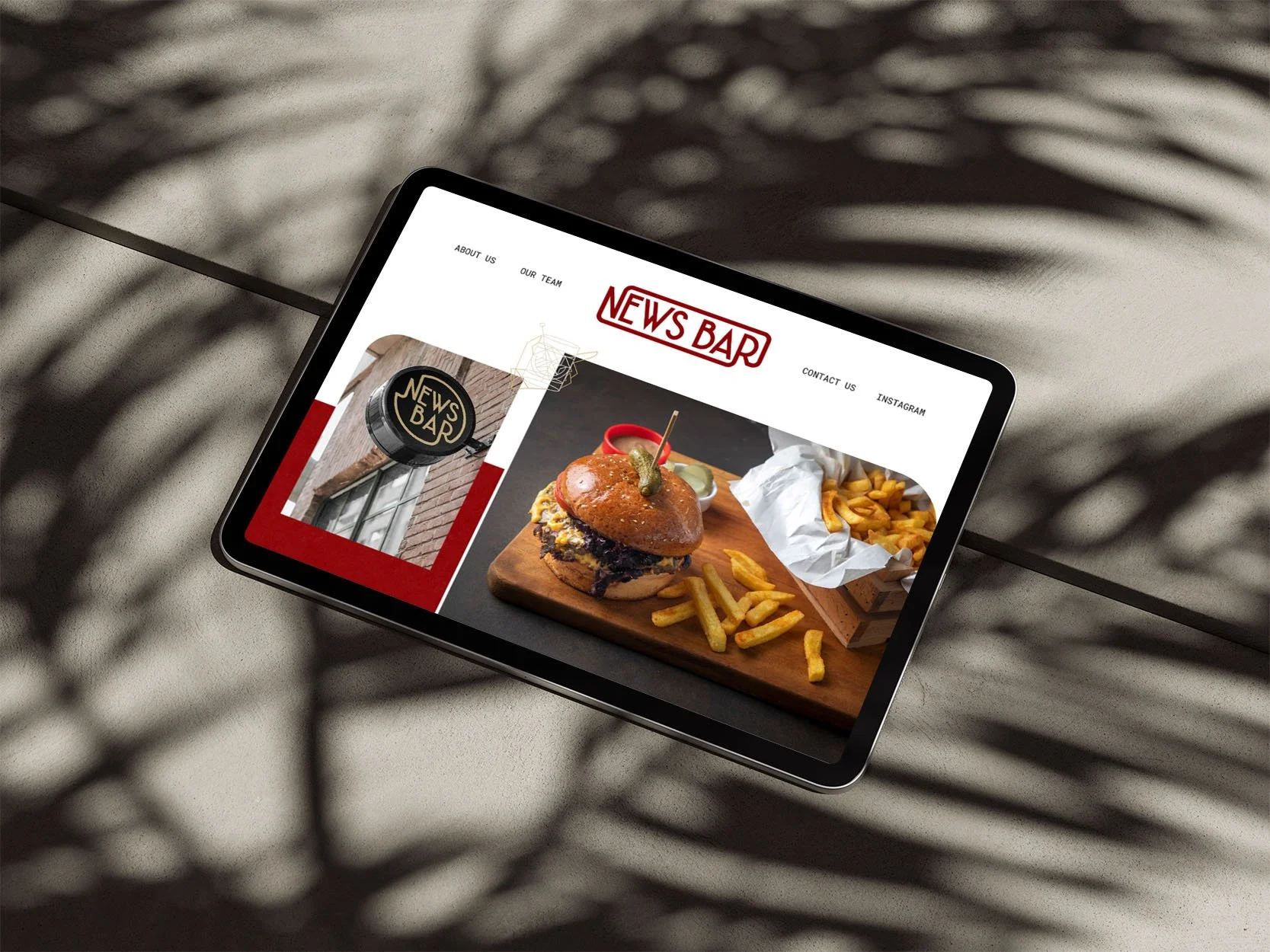 An ipad on the concrete ground showing a restaurant website.